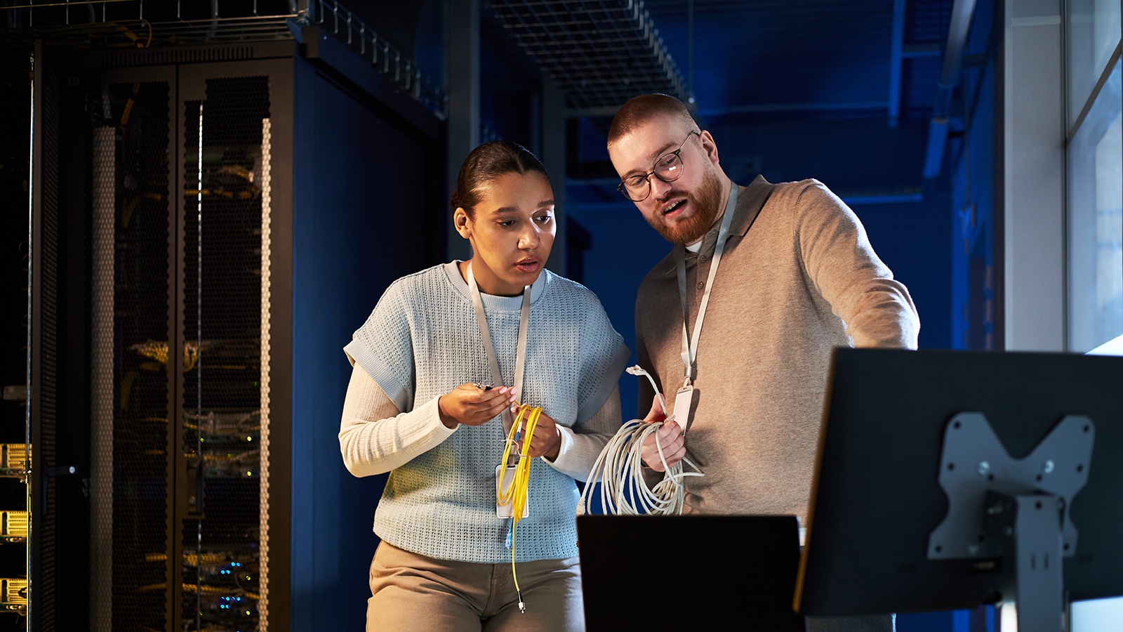 IT professionals setting up network infrastructure