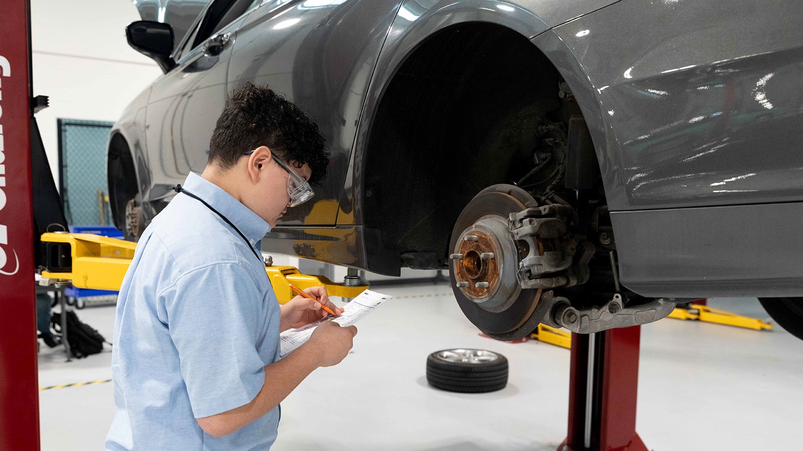 Automotive mechanic inspecting a brake rotor