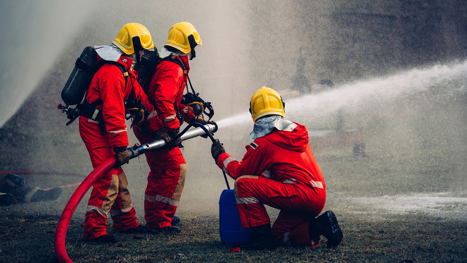 Firefighters Battling Blaze with Water and Extinguishers.
