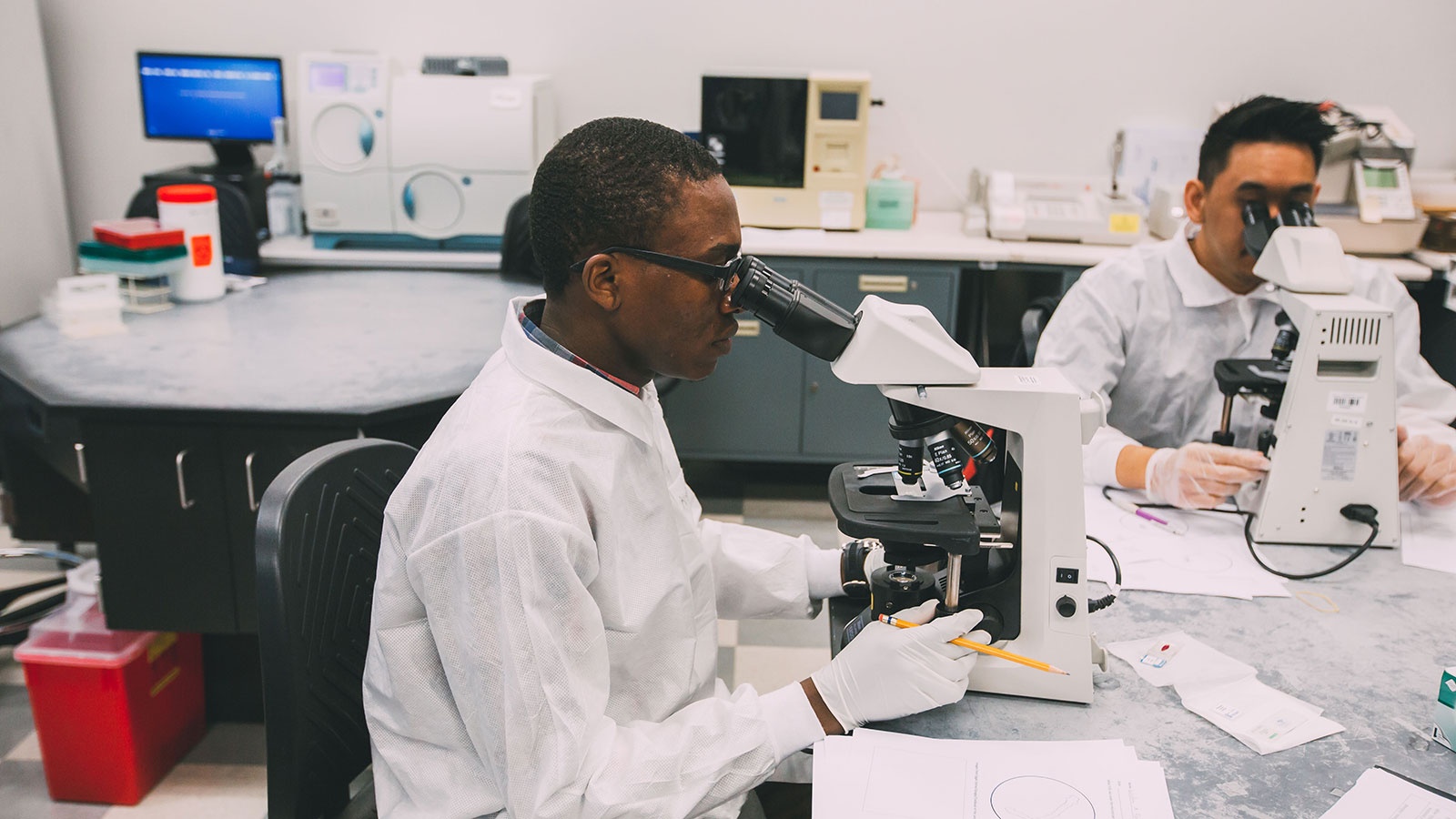 Student looking through a microscope