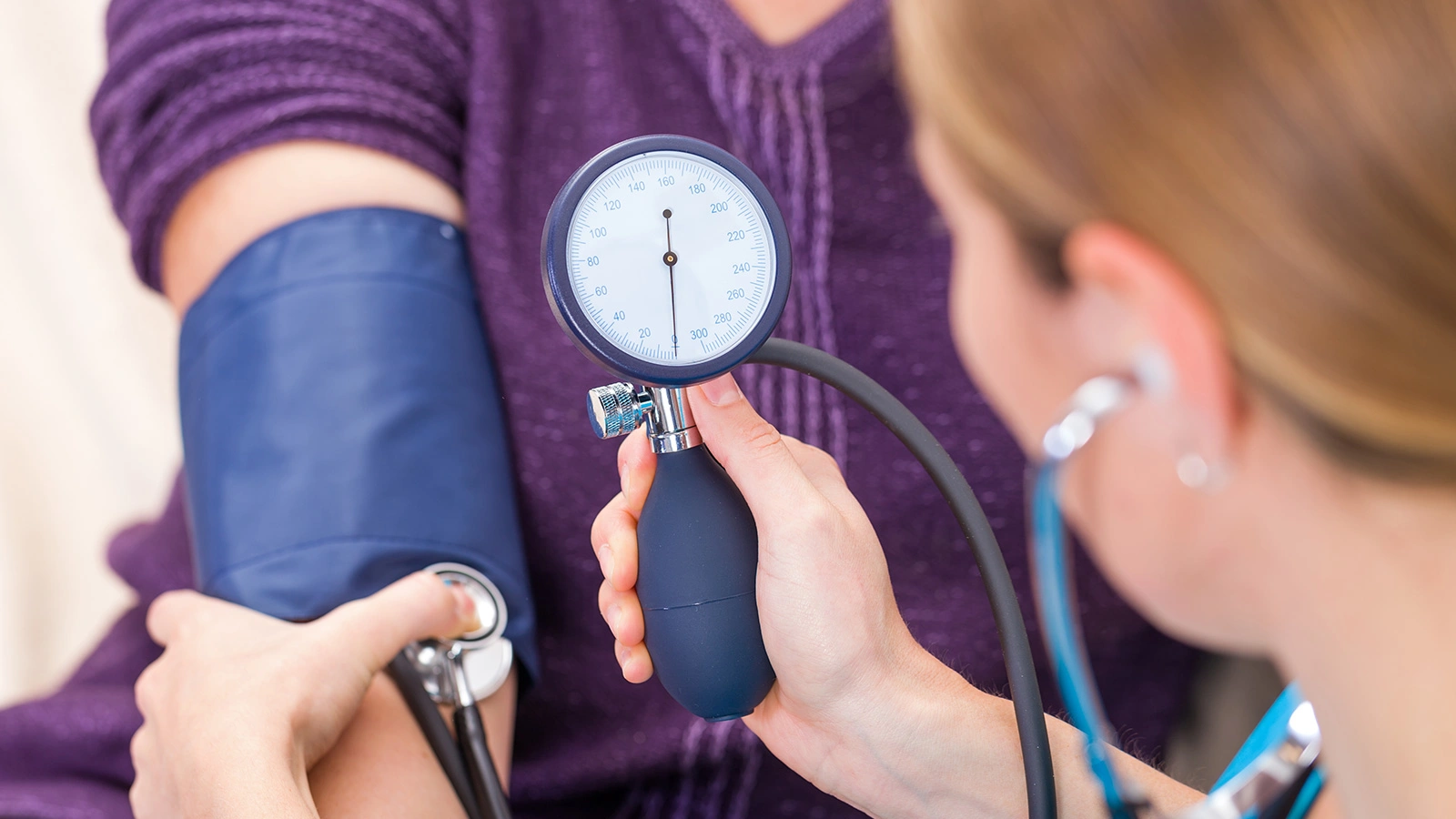 Nurse checking blood pressure