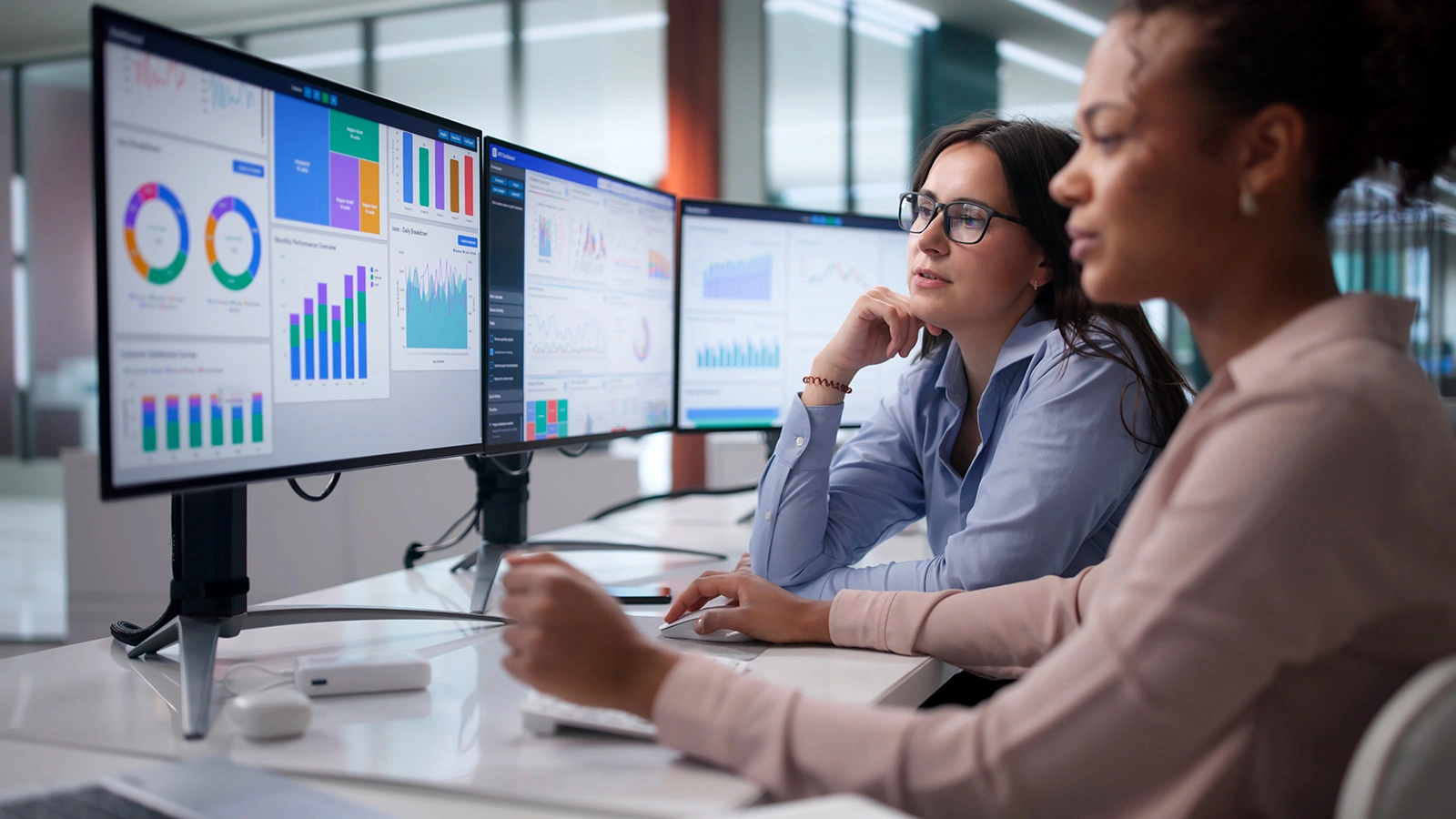 Two Women On Analytics Team Analyzing Data