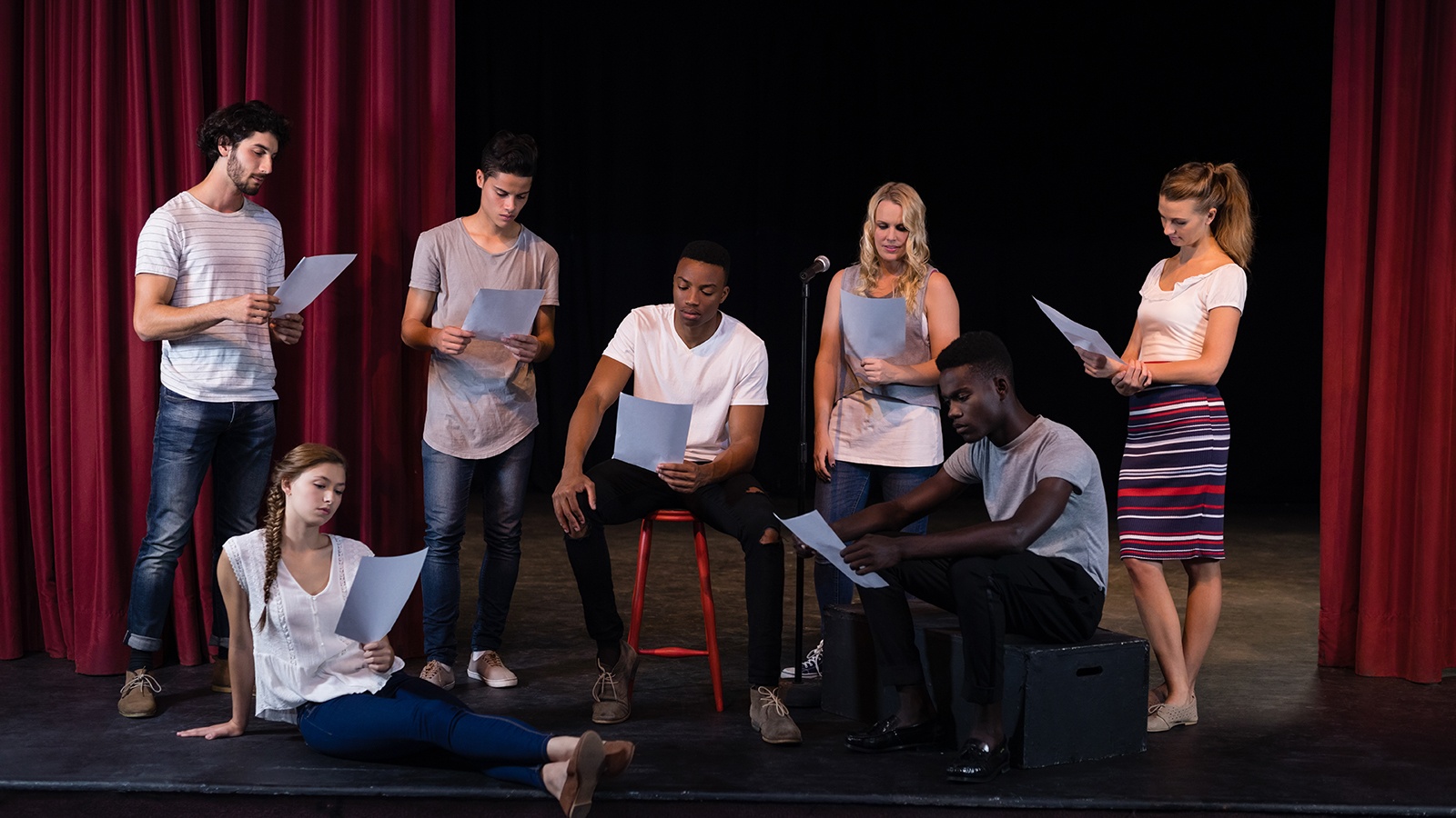 Drama students acting out a scene on stage