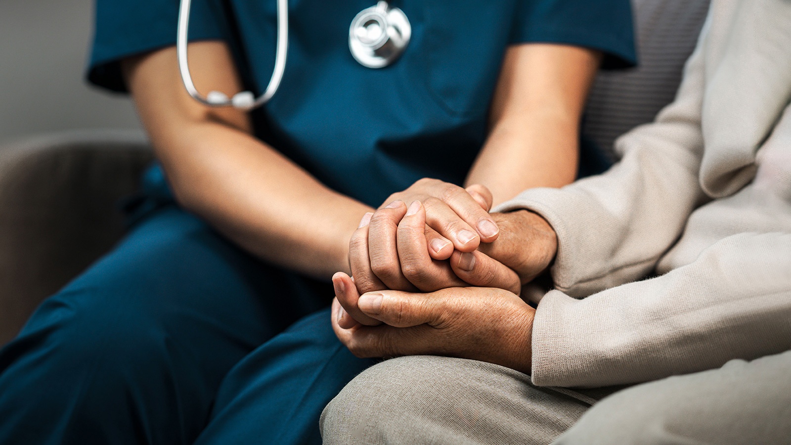 Nurse holding patient's hands