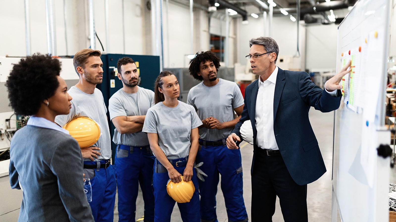 Manager explaining strategy plans to a group of employees