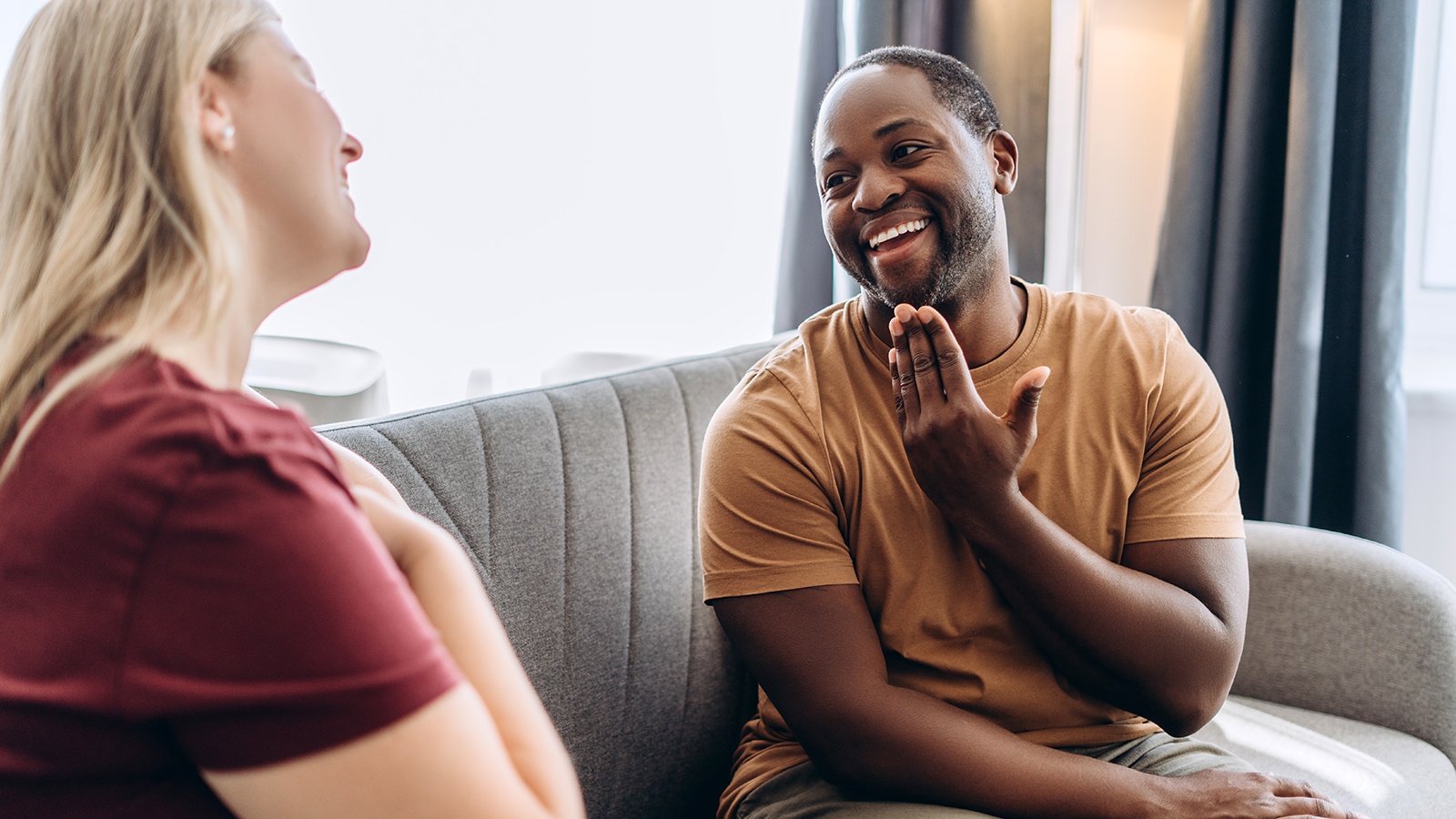Two individuals communicating using sign language