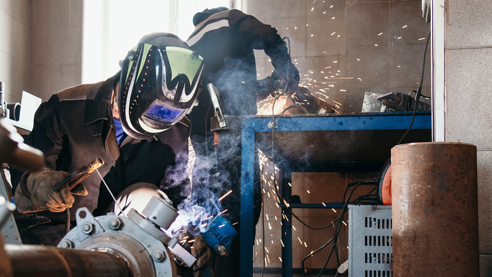 Welding Technician working on metal pipe in workshop