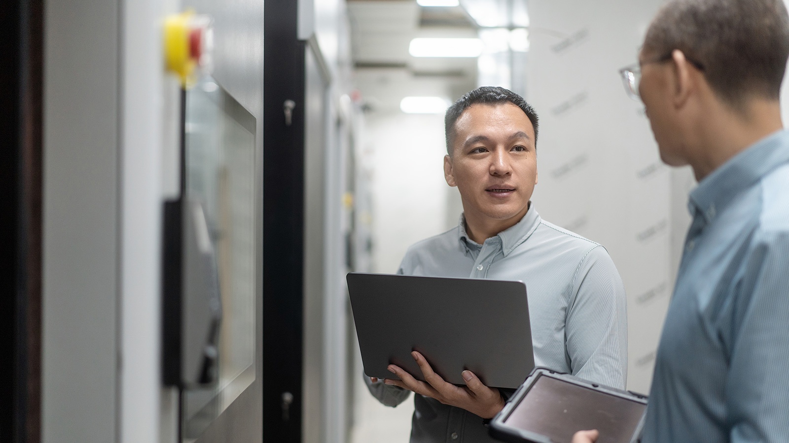 IT team co working with tablet in server room