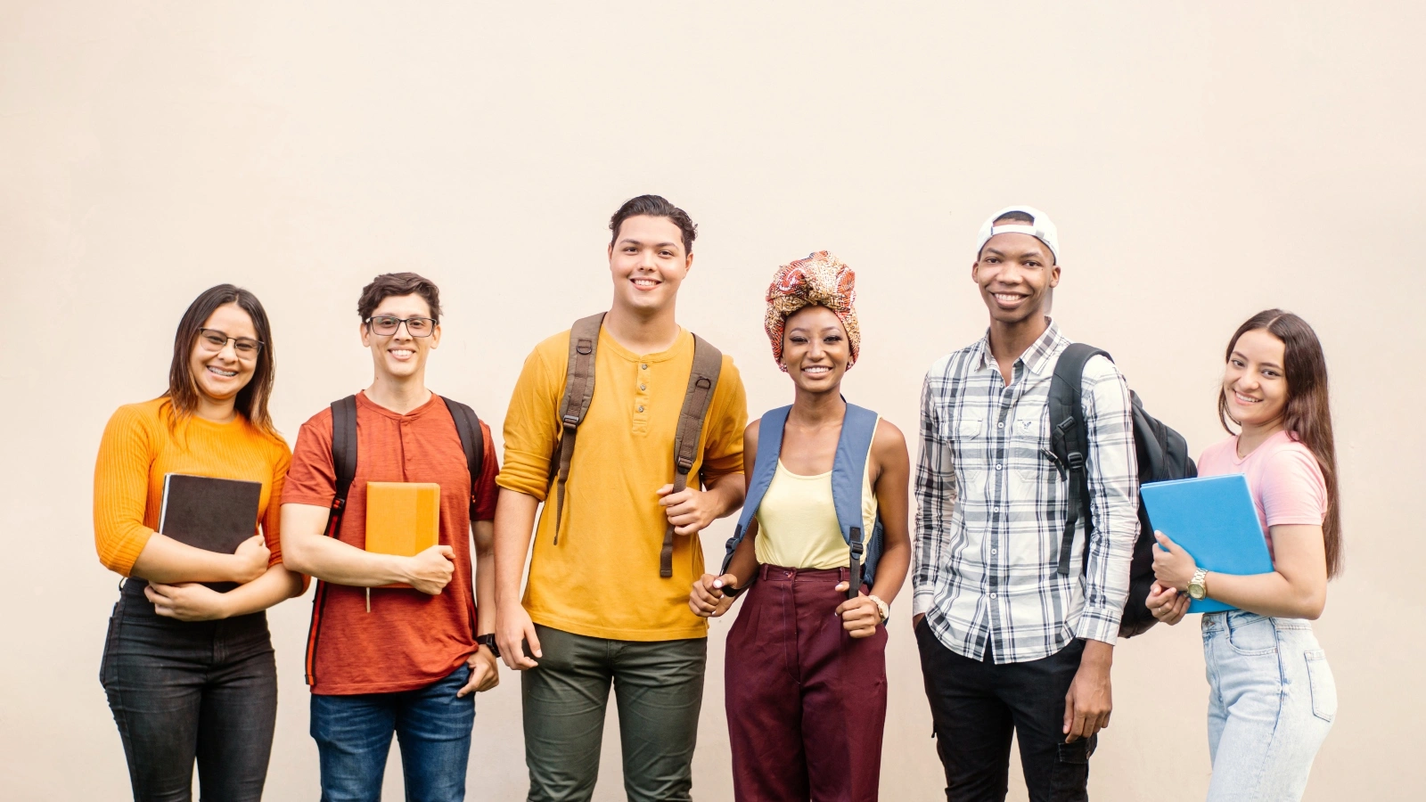 Group of young college students with backpacks.