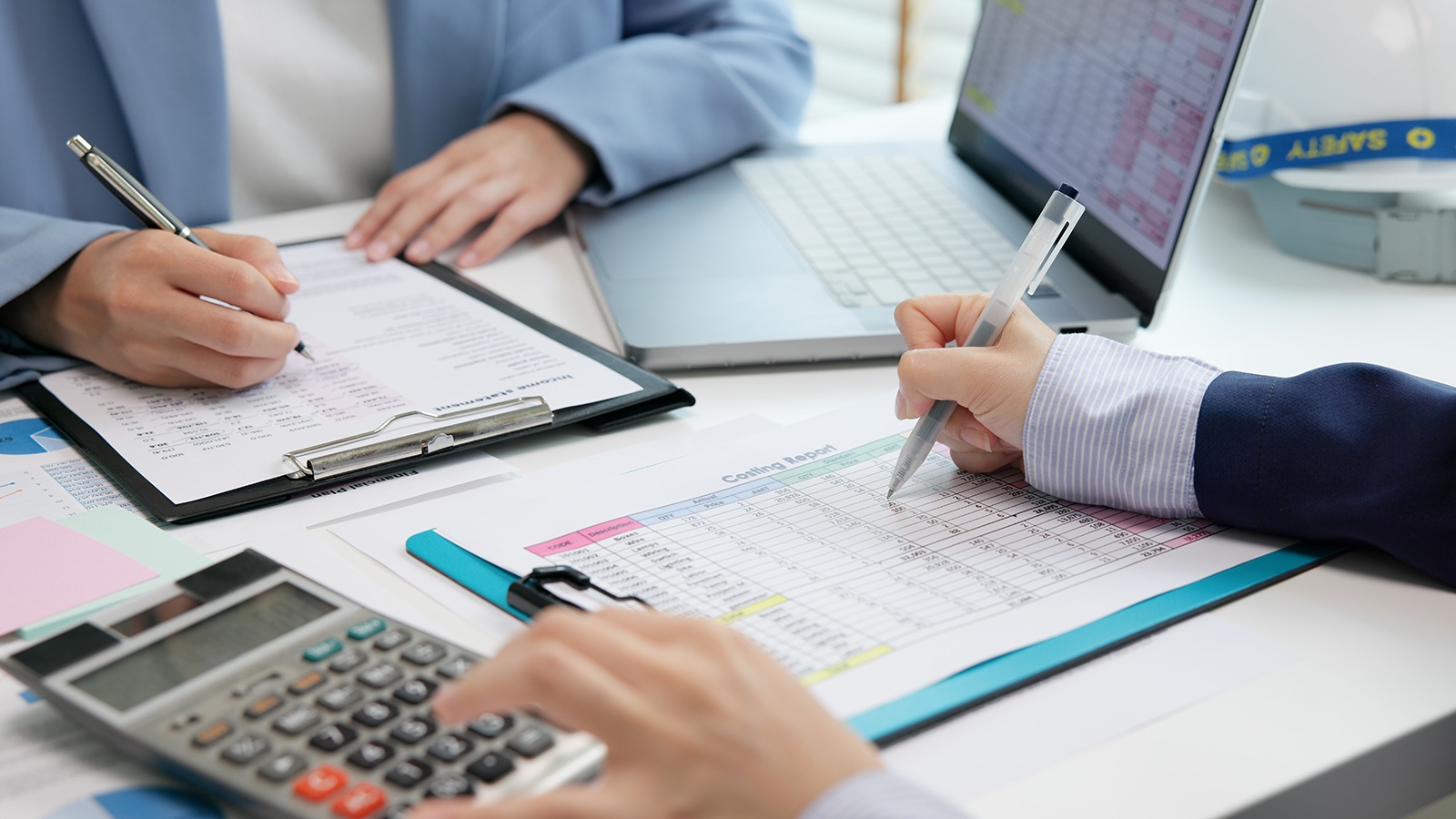 Two people working on financial data