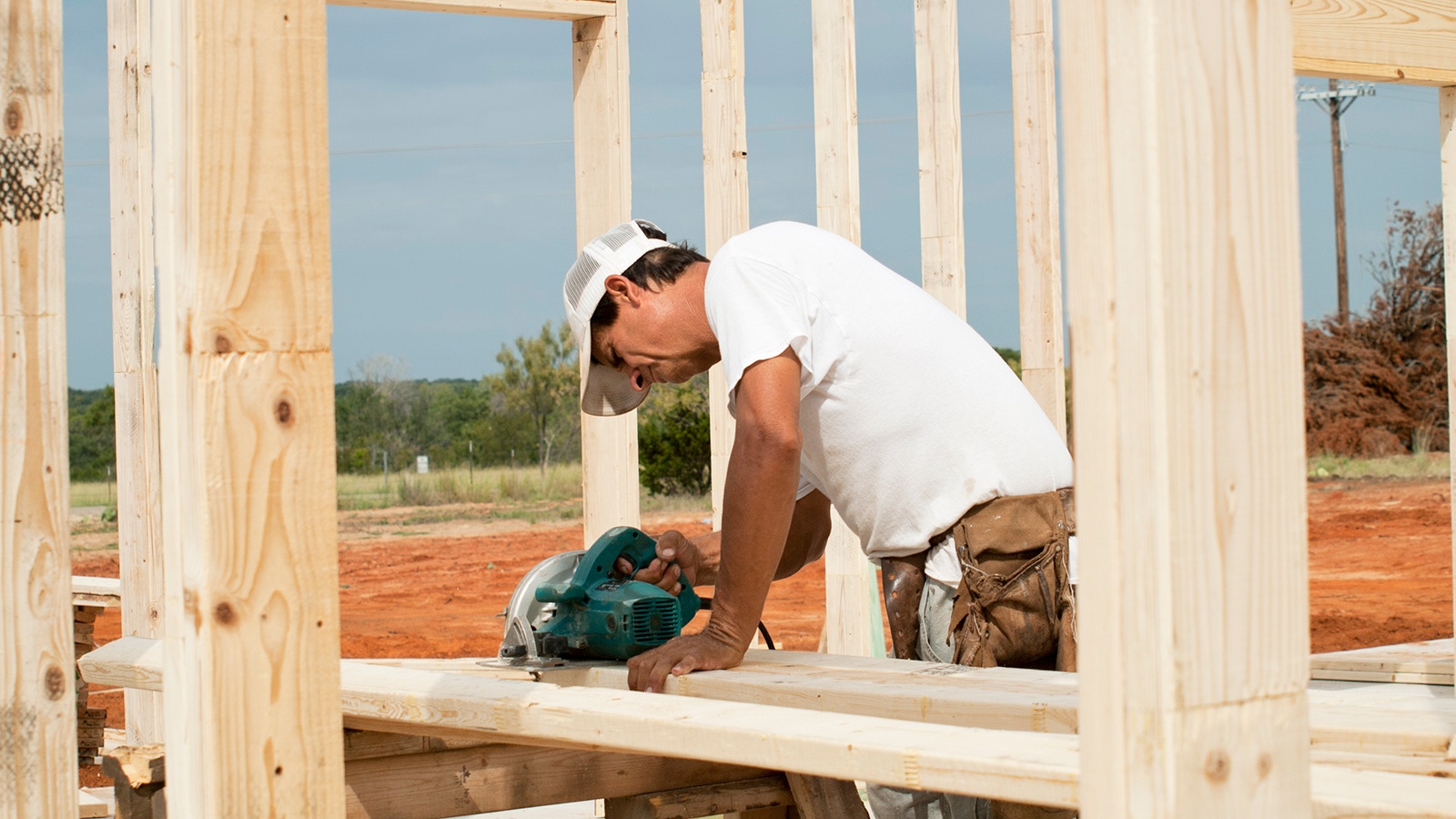Framer sawing piece of lumber