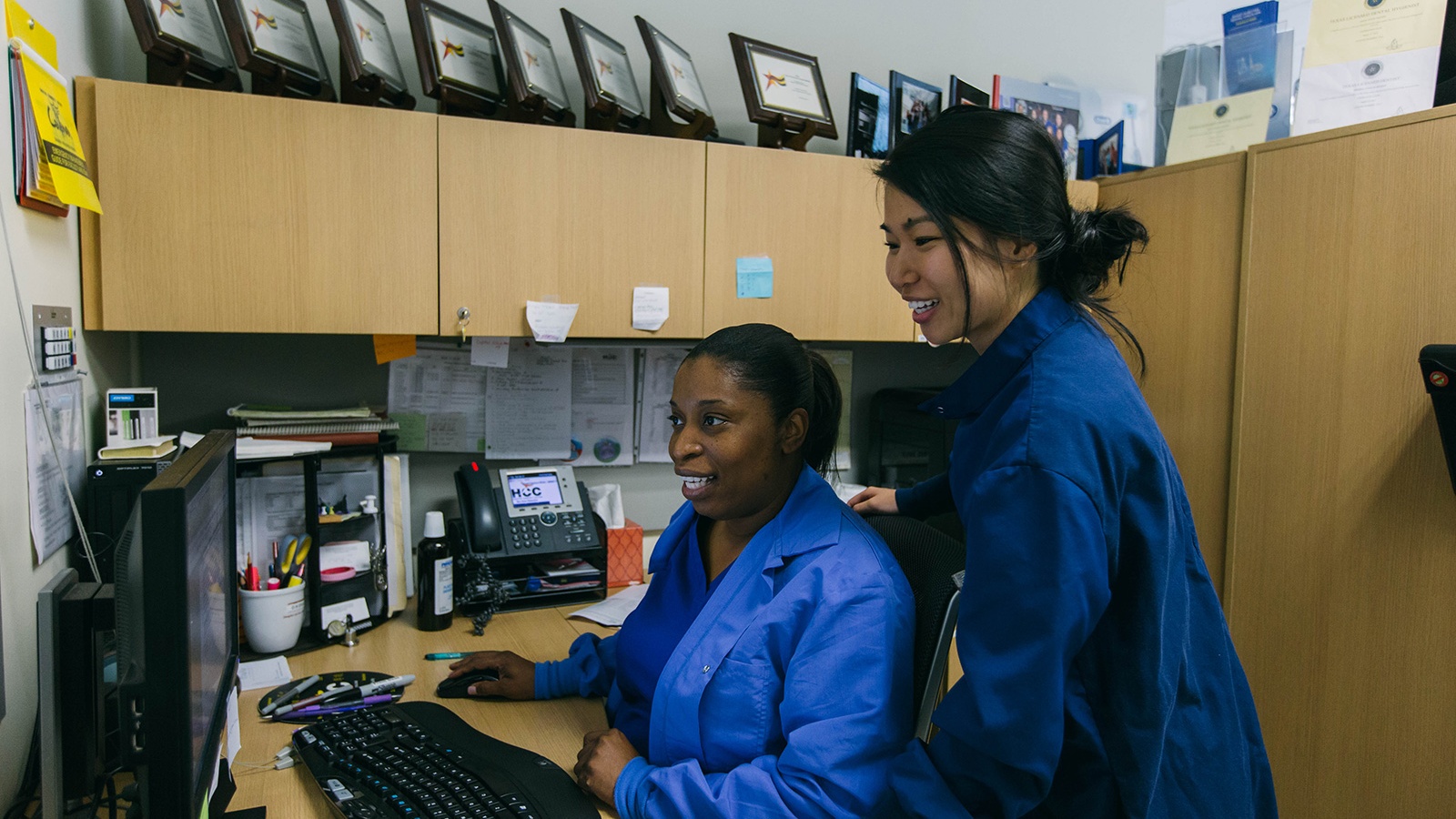 Two women working as a medical office business professional.