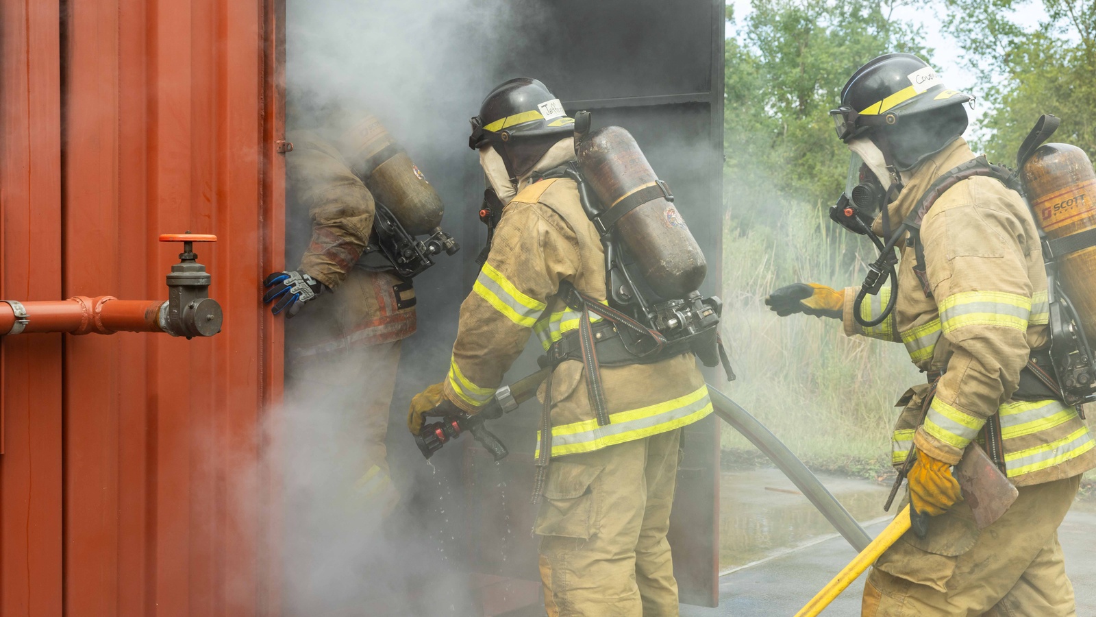 Fire academy students entering into a smoke filled  space