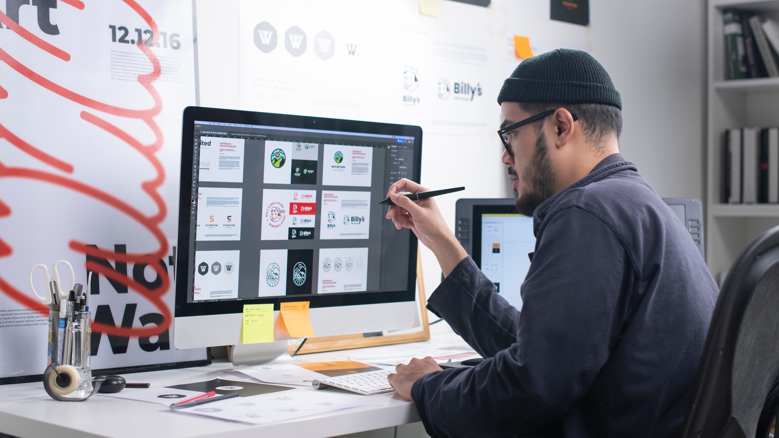 A person using a computer to draw digital designs