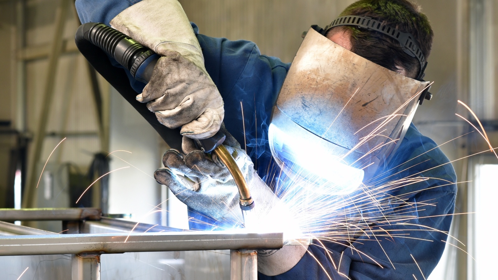A Welder using a welding machine