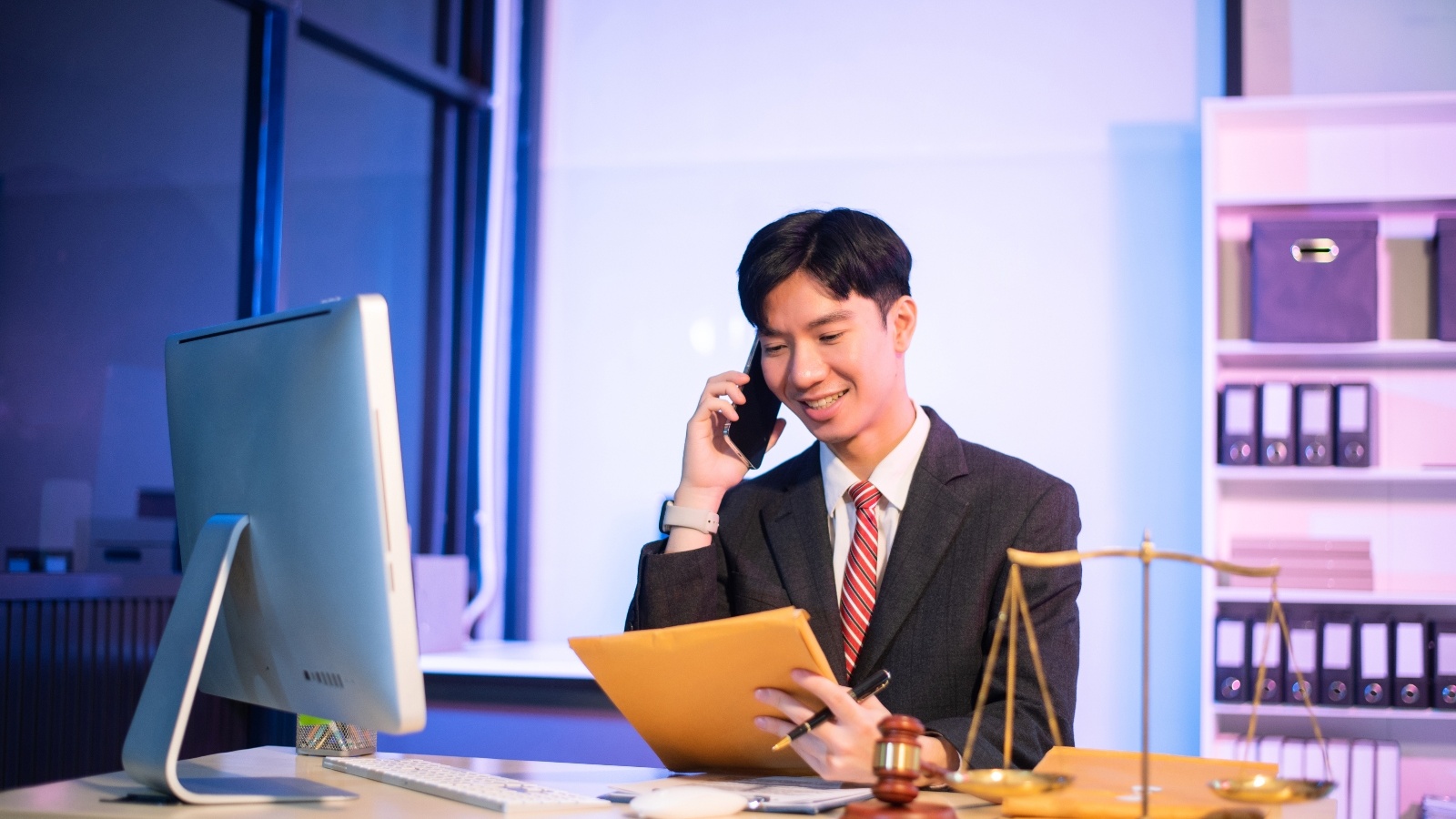 Paralegal on a phone call while looking at documents