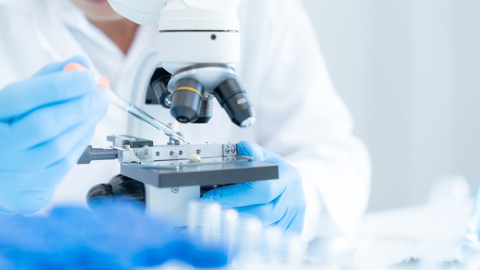 Medical Biotechnology technicians observing slides under a microscope