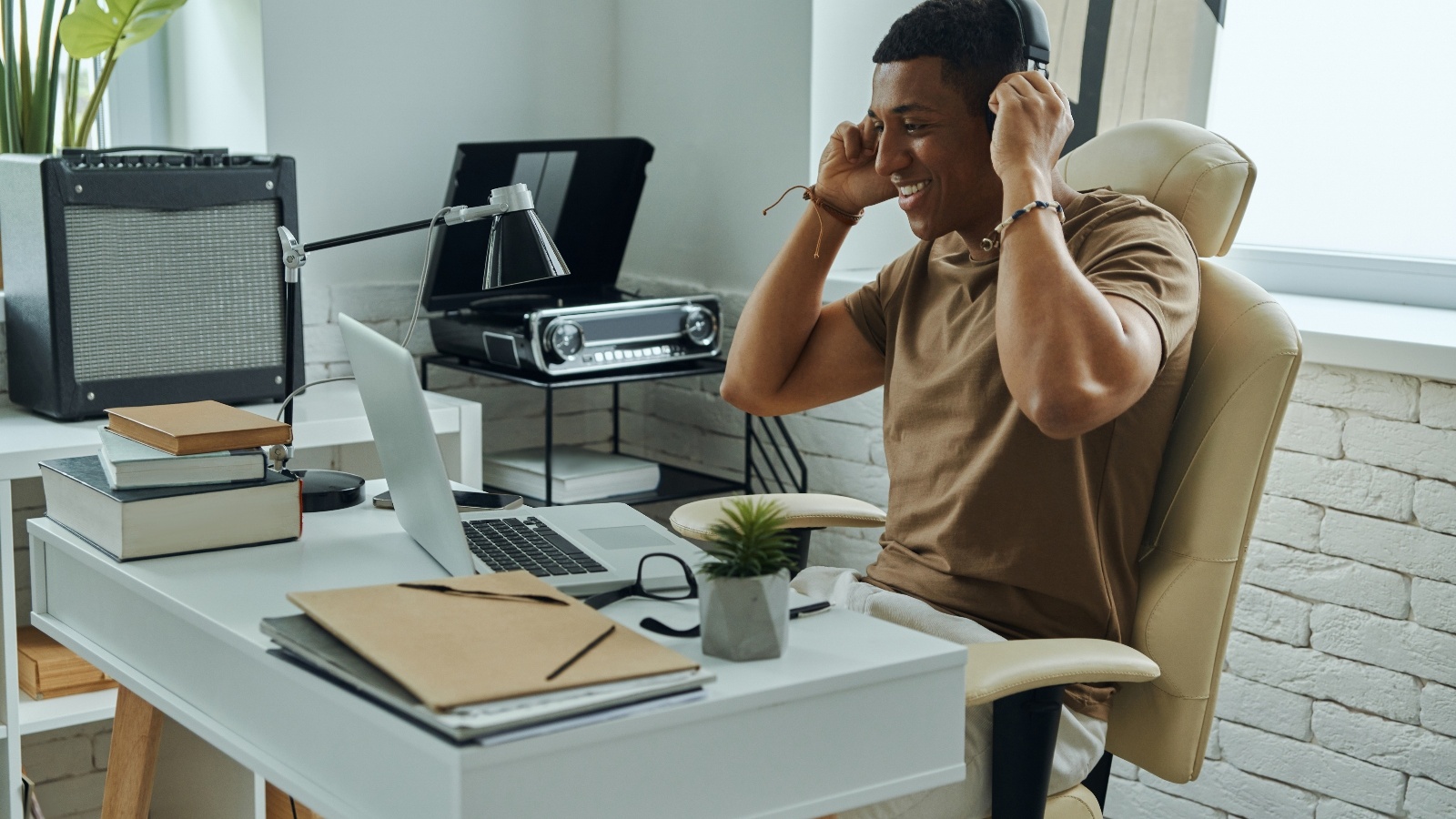 Music engineer at his desk listening to music.