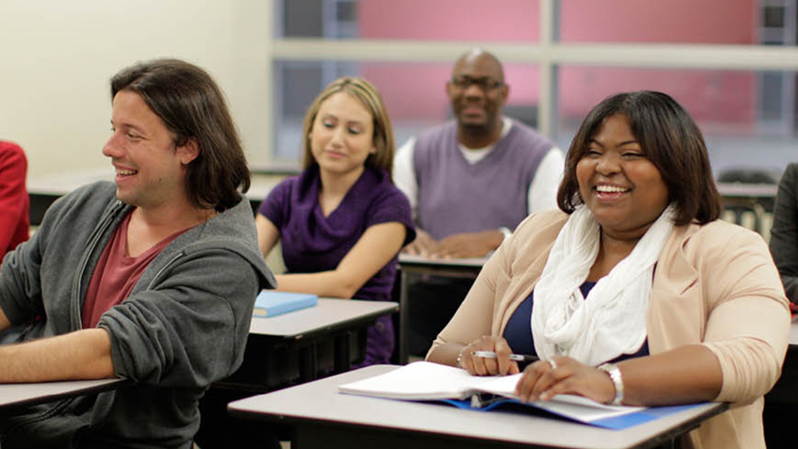 Students in a class room environment engaging in learning.