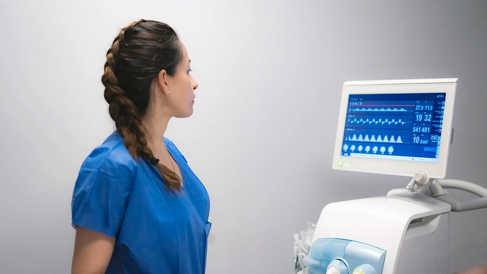 Nurse monitoring patient vital signs on EKG