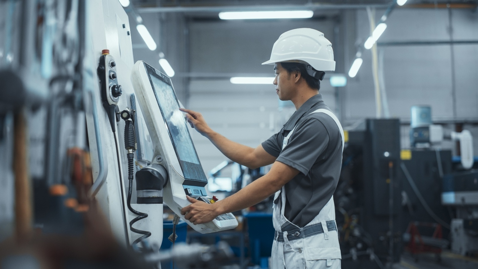 Machinist students operating a machine.
