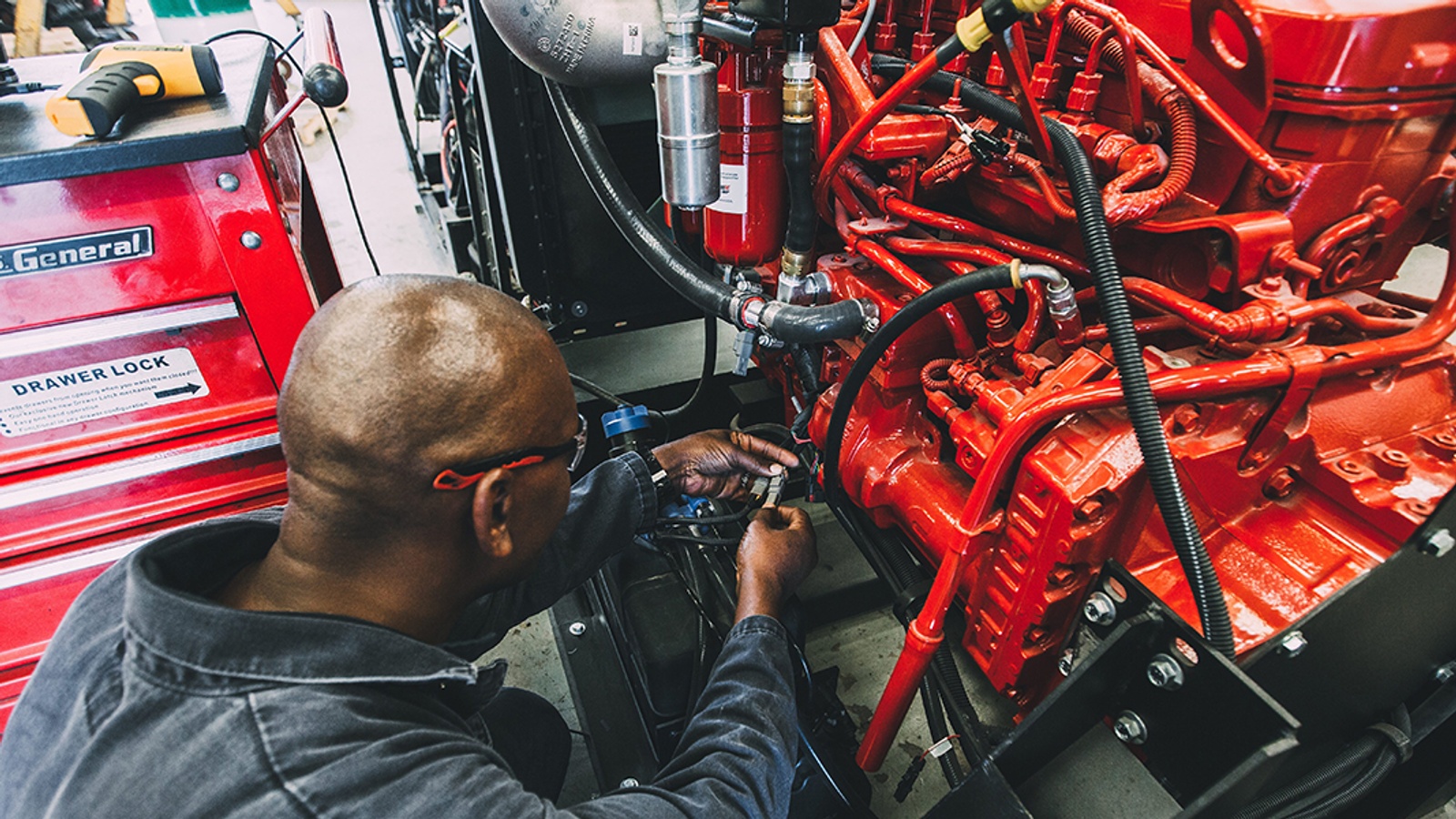 Mechanic working on a large diesel engine