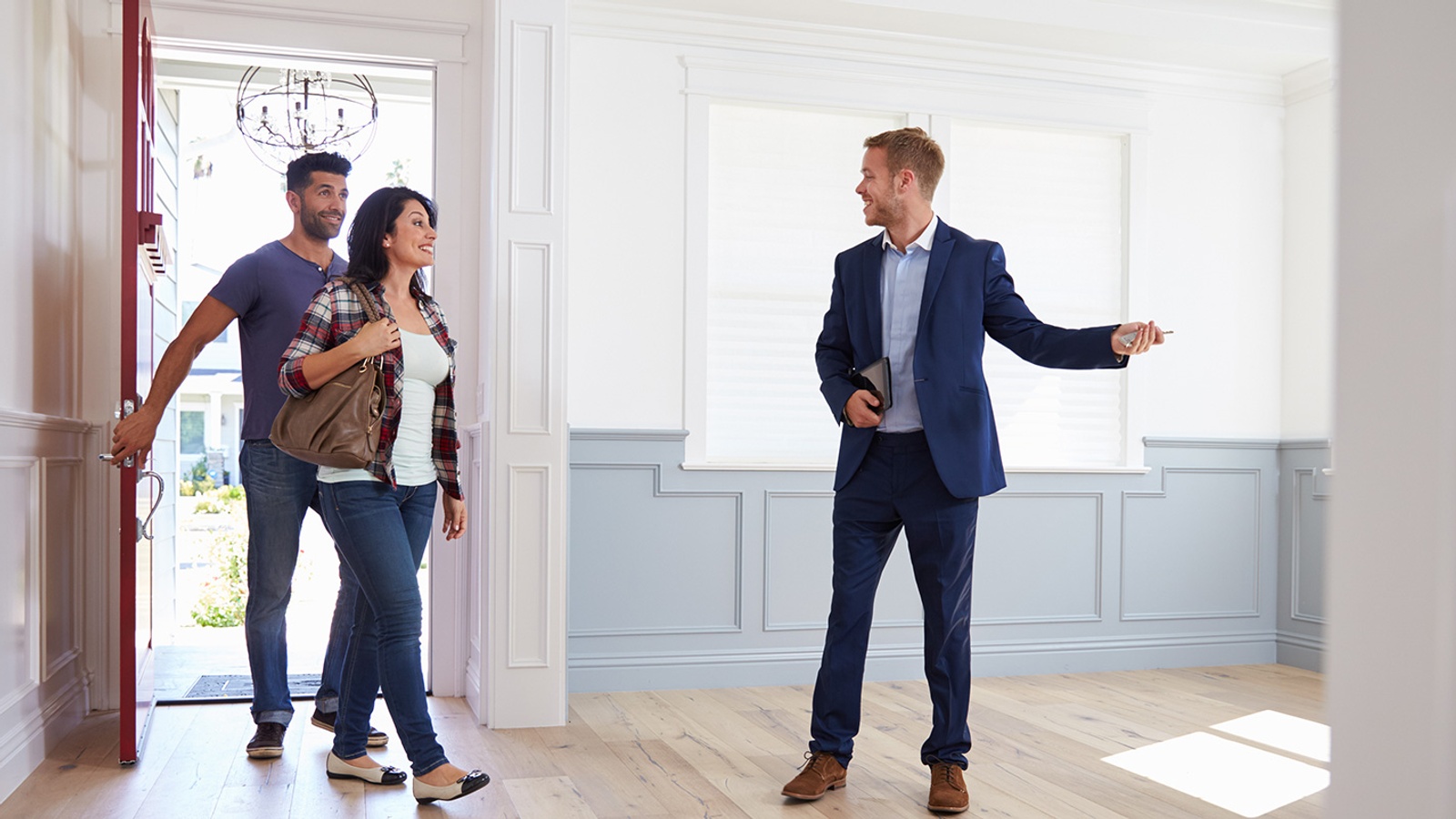 Real Estate Agent Showing a Couple Around New Home