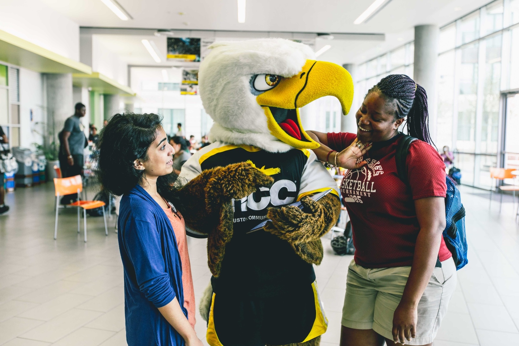 HCC Students in a student break area with HCC mascot Swoop