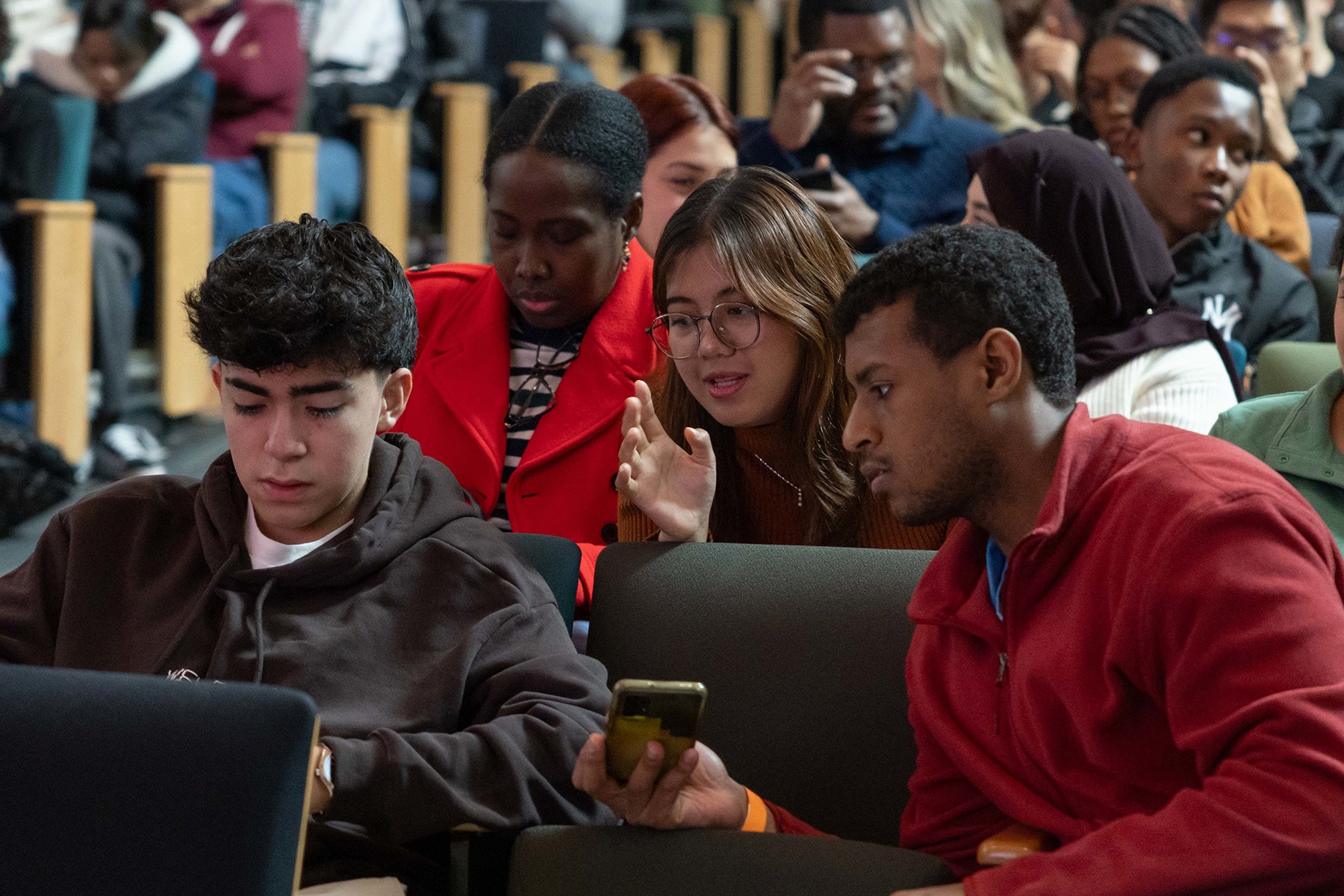 HCC Students talking in an auditorium