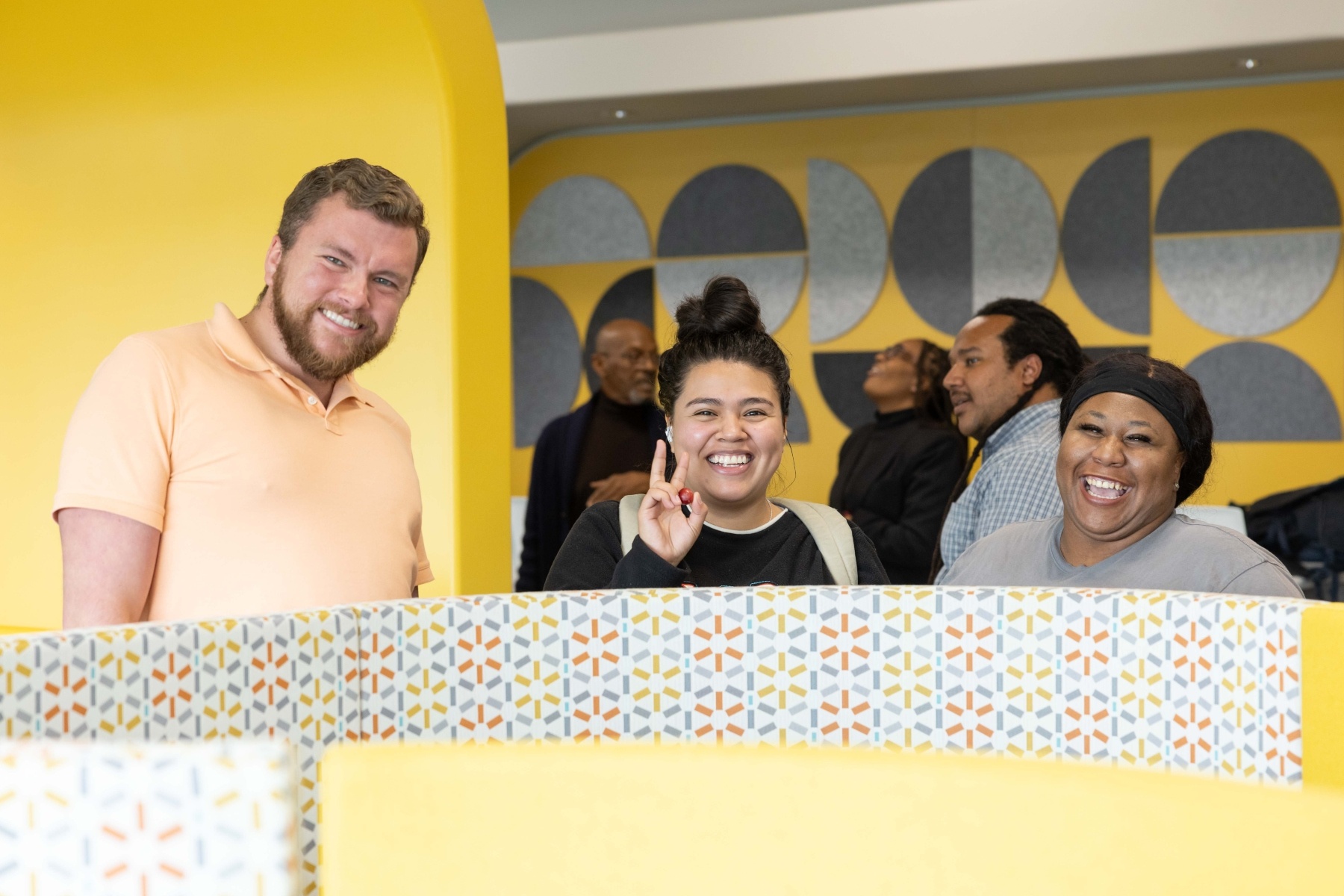 A diverse trio of students pose for a photo at an event.
