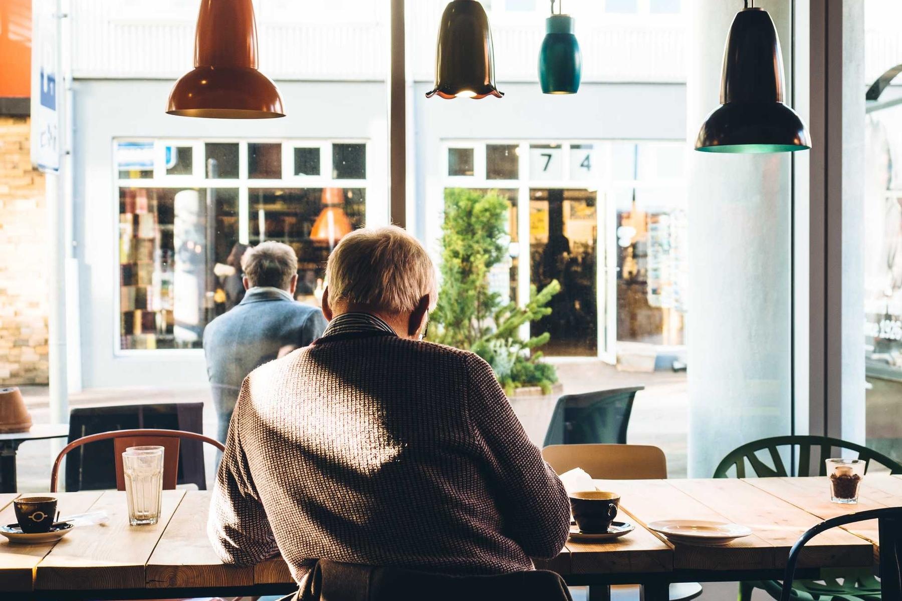 Person sat at table in a coffee shop