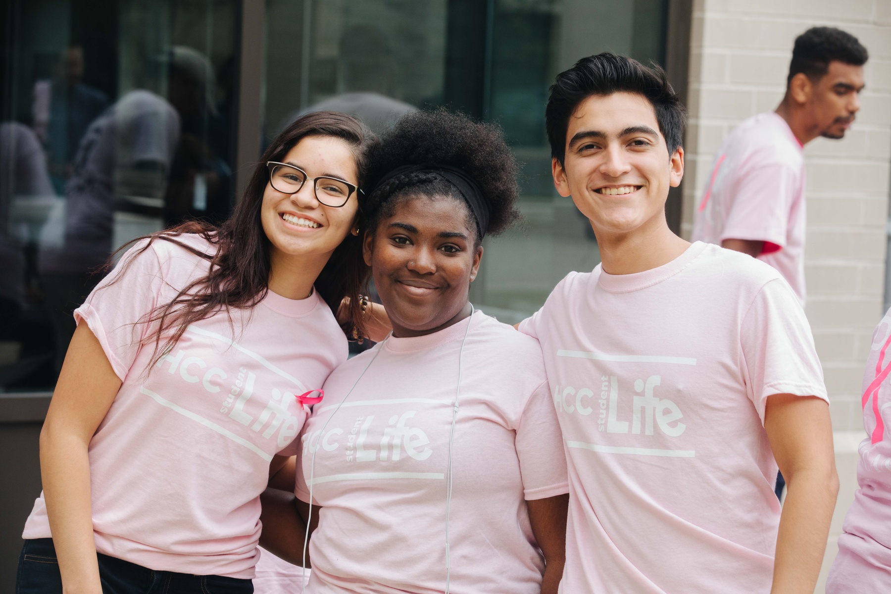 Three HCC students standing side-by-side and smiling