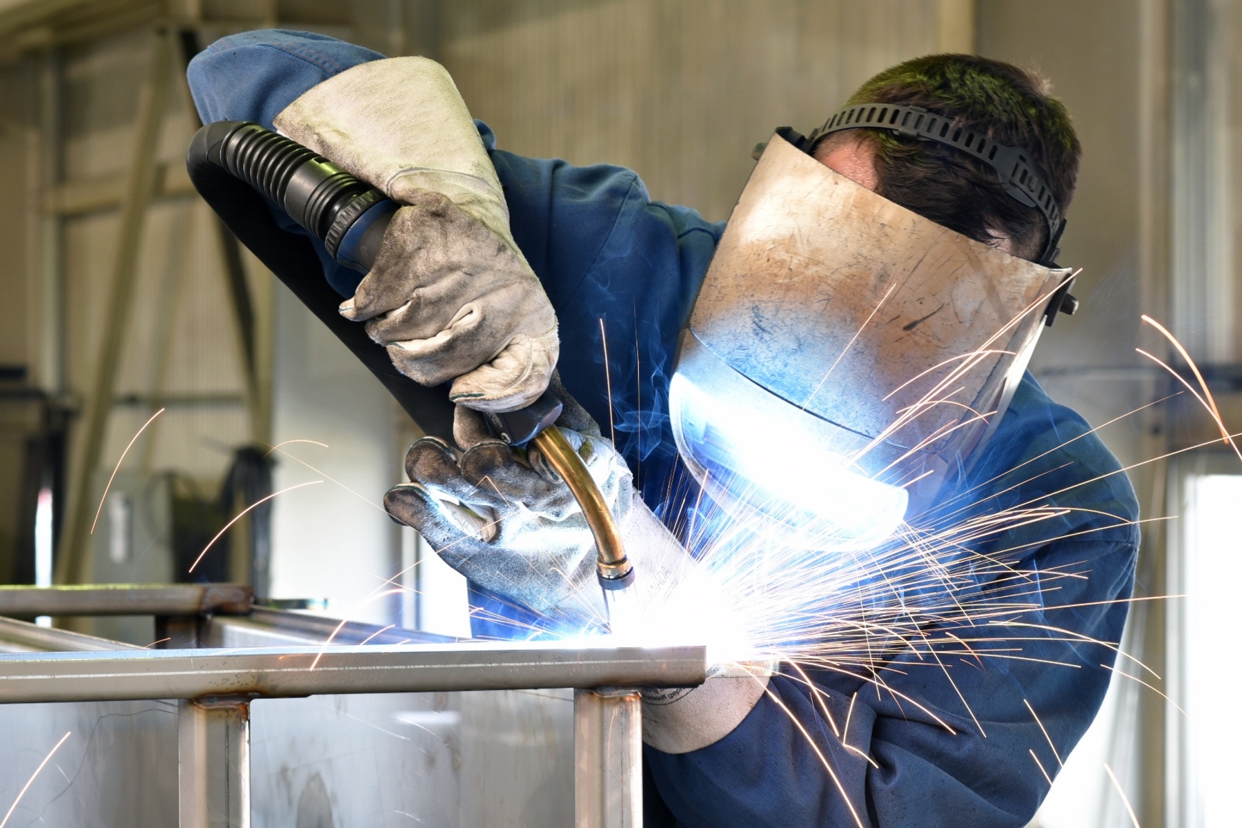 A Welder using a welding machine