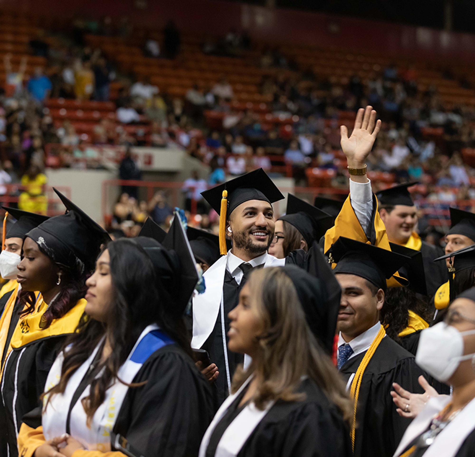 HCC Graduate waving at commencement