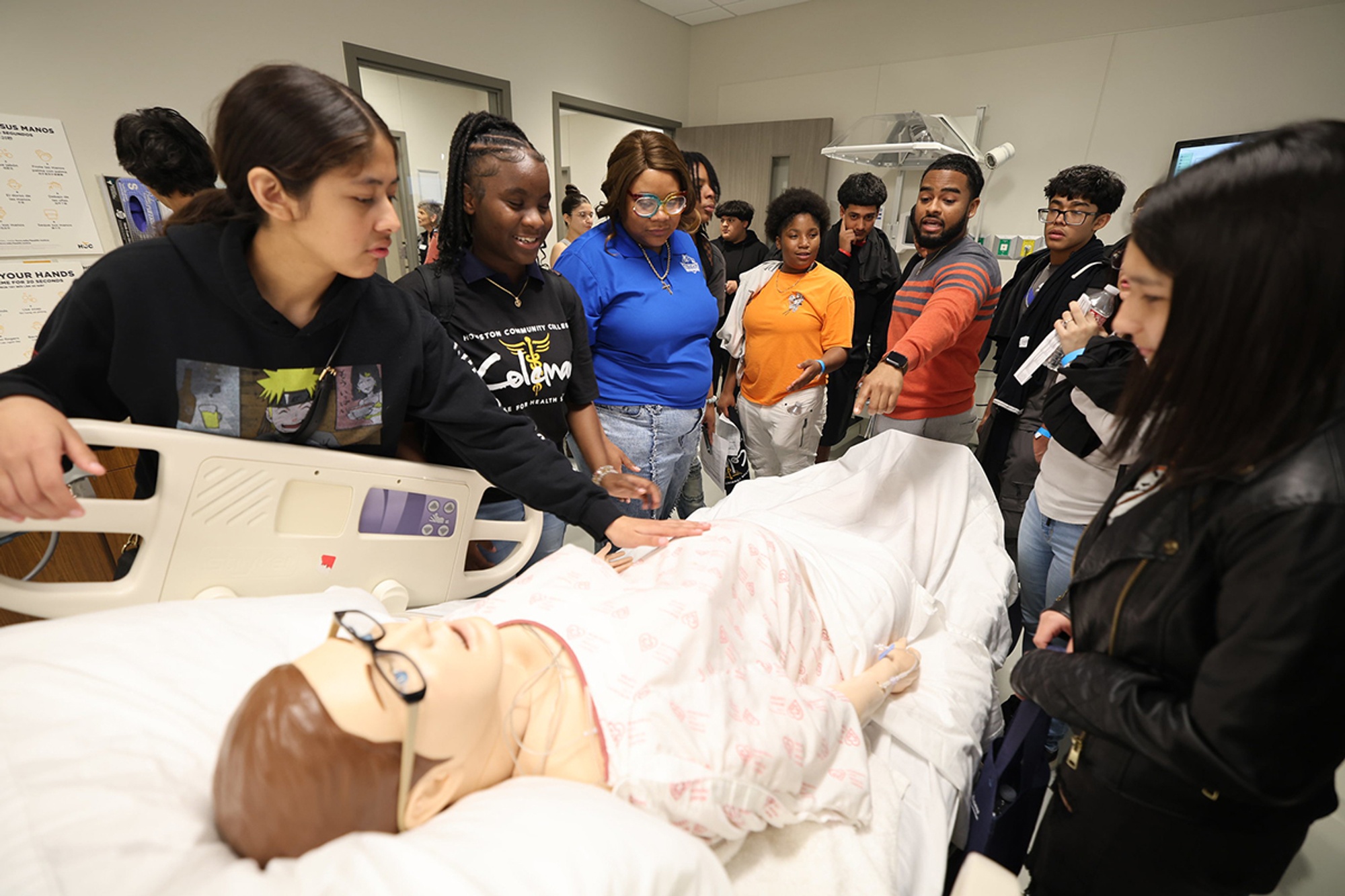 Students examining a simulated medical patient