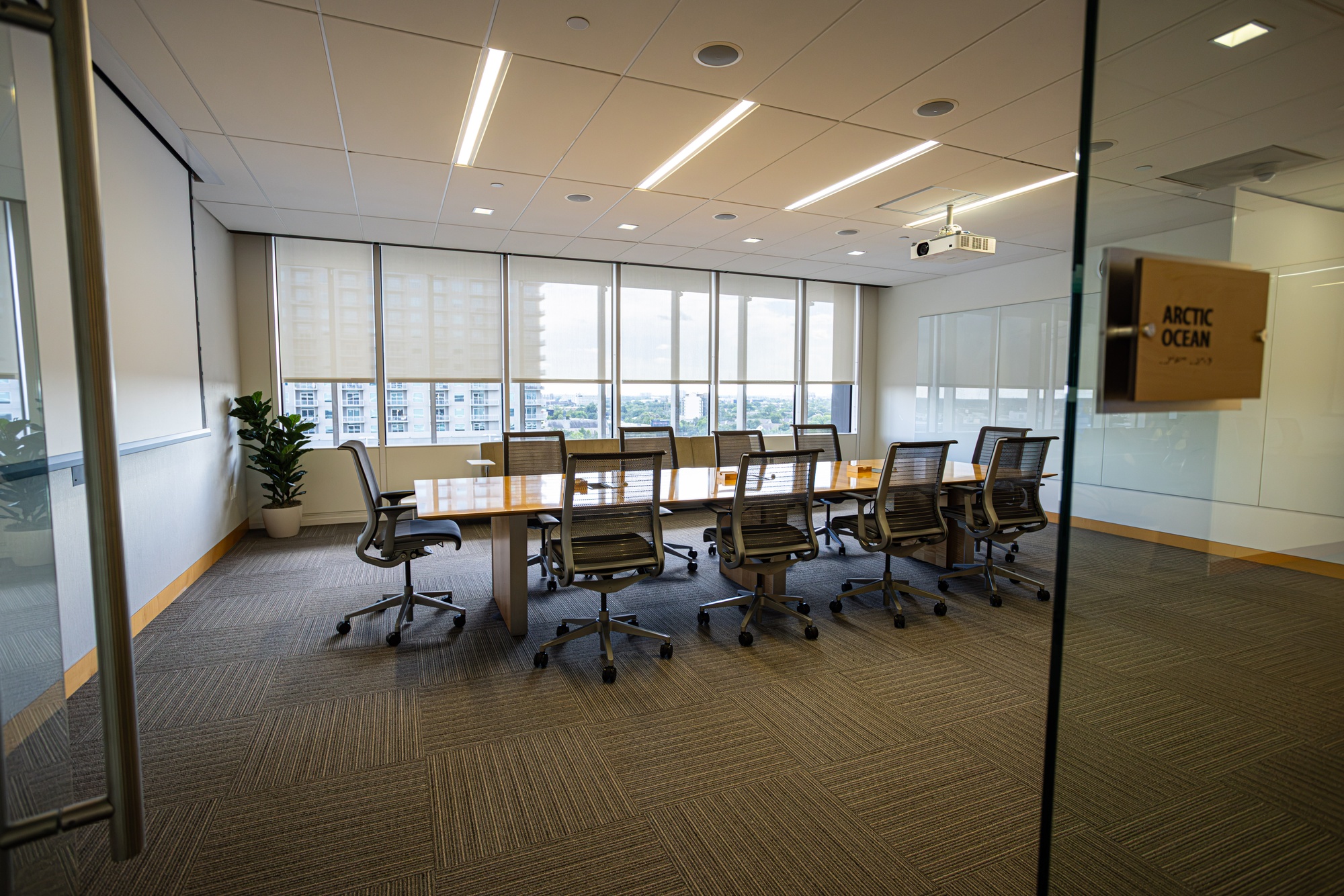 A conference room with a table and multiple chairs.