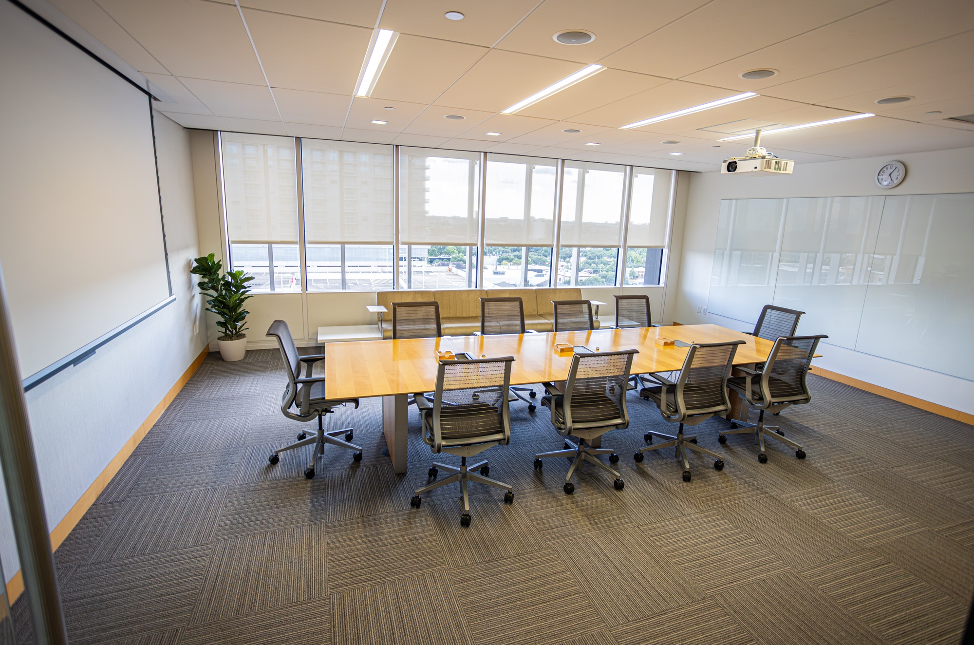 A conference room with a table and multiple chairs.