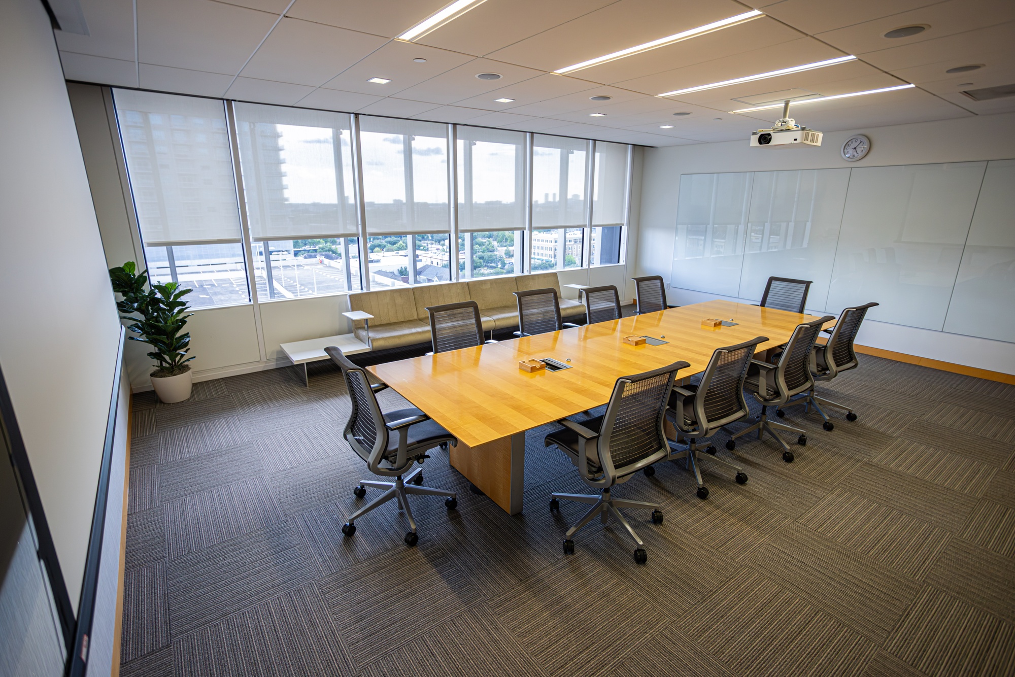 A conference room with a table and multiple chairs.