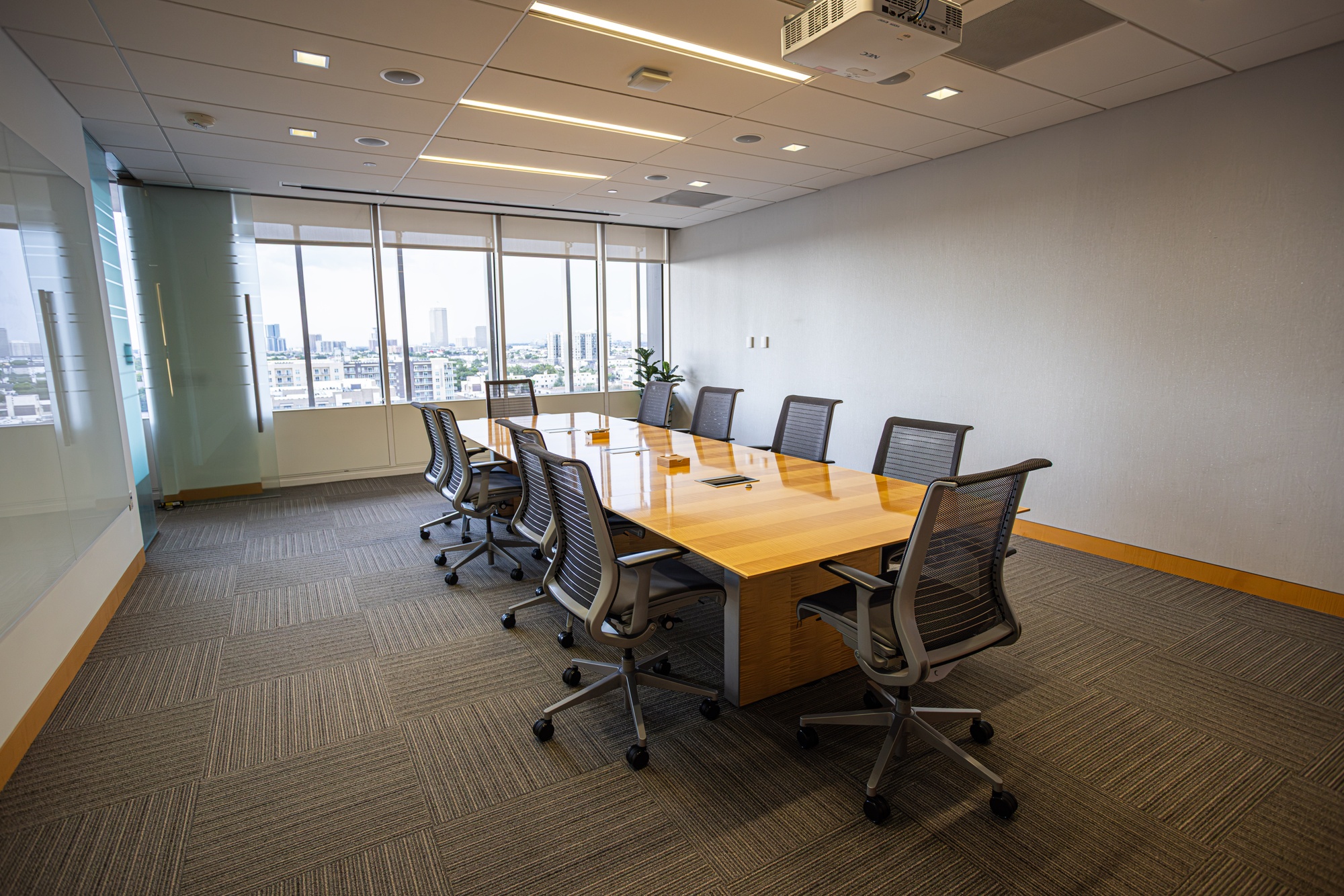A conference room with a table and multiple chairs.