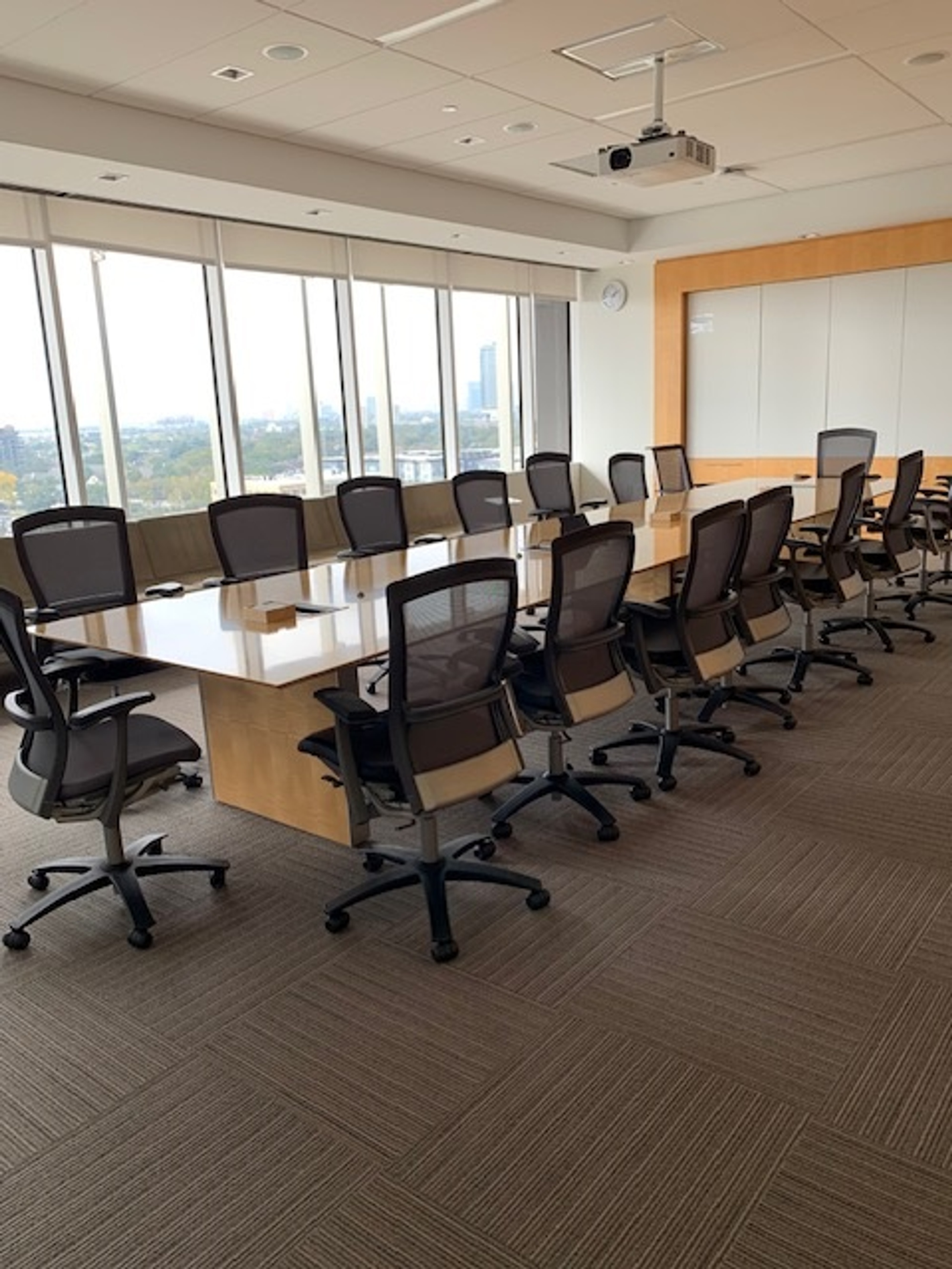 Interior photo of the meeting room space of the Pacific Ocean room showcasing the windowed view of the city.