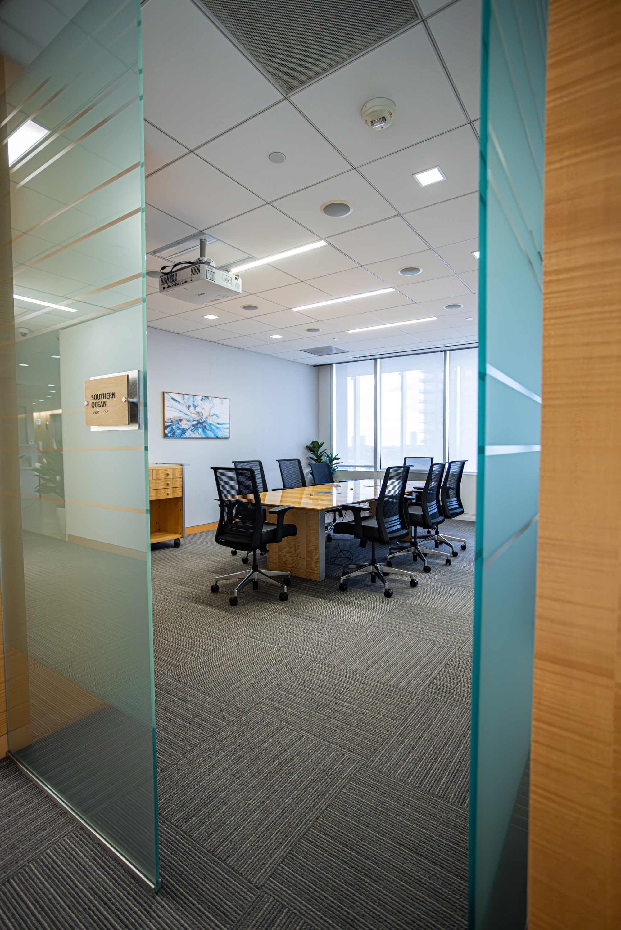 A conference room with a table and multiple chairs.
