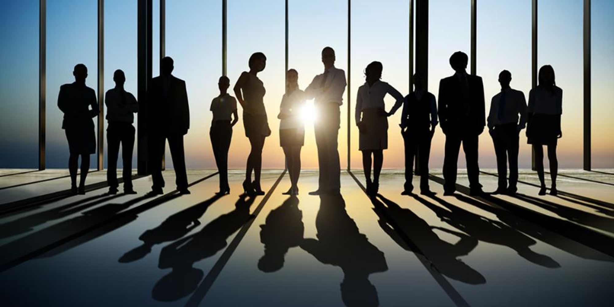 A group of silhouetted business professionals.