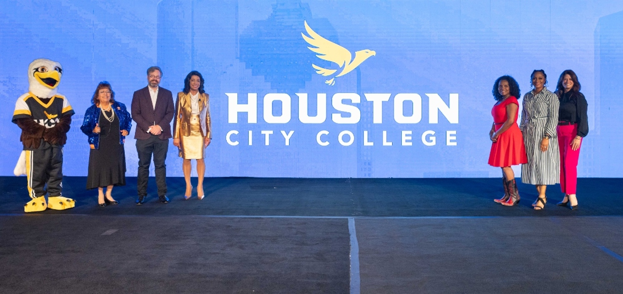 HCC officials display the college's new name and logo.