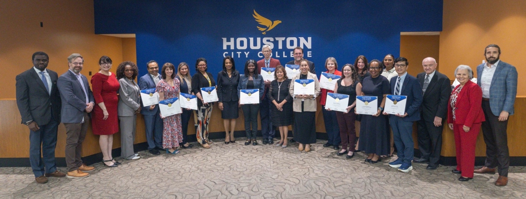 HCC faculty, staff and administrators pose for a photo during a Board of Trustees meeting.