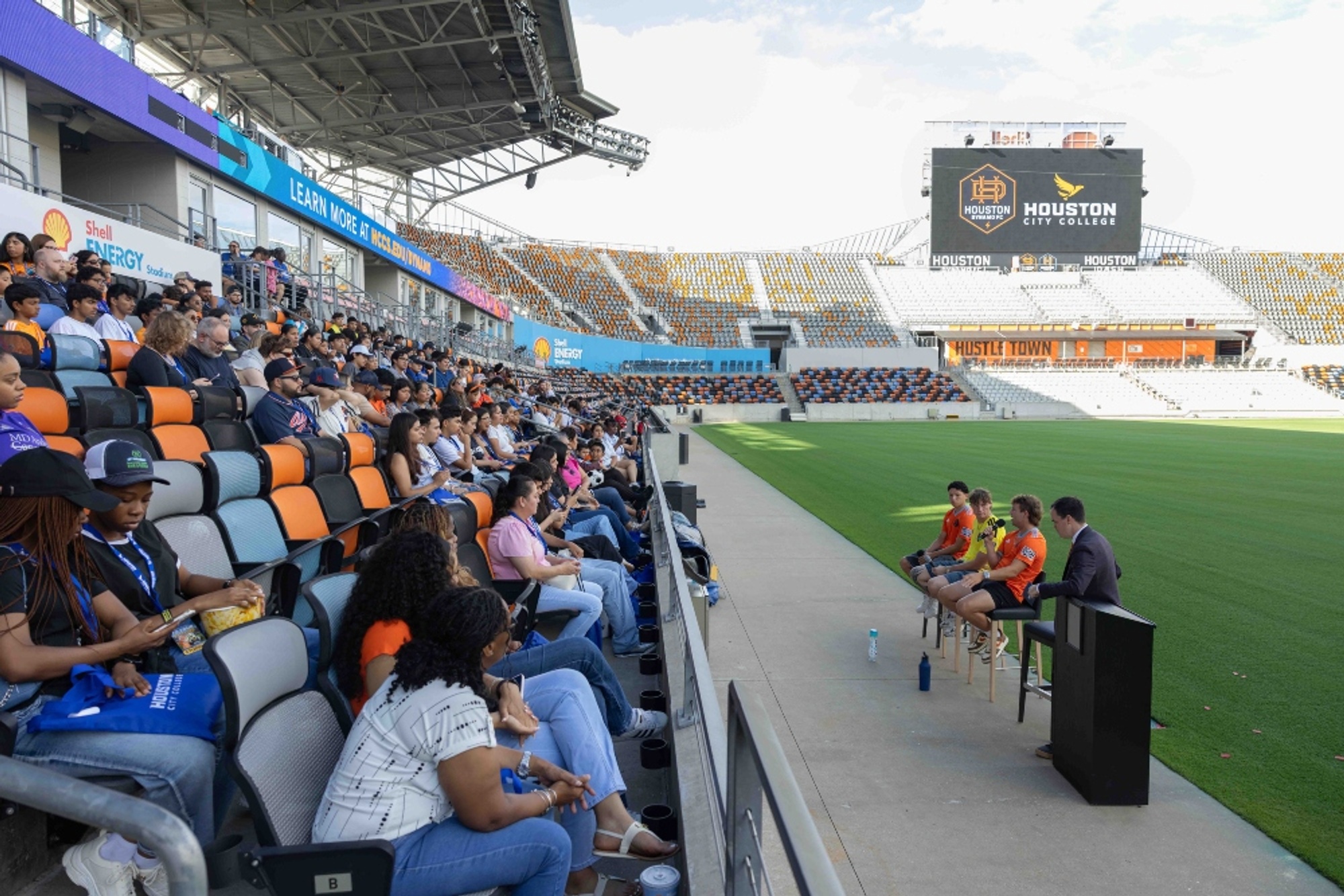 Houston Dynamo players take questions from HCC students in the stands at Shell Energy Stadium.