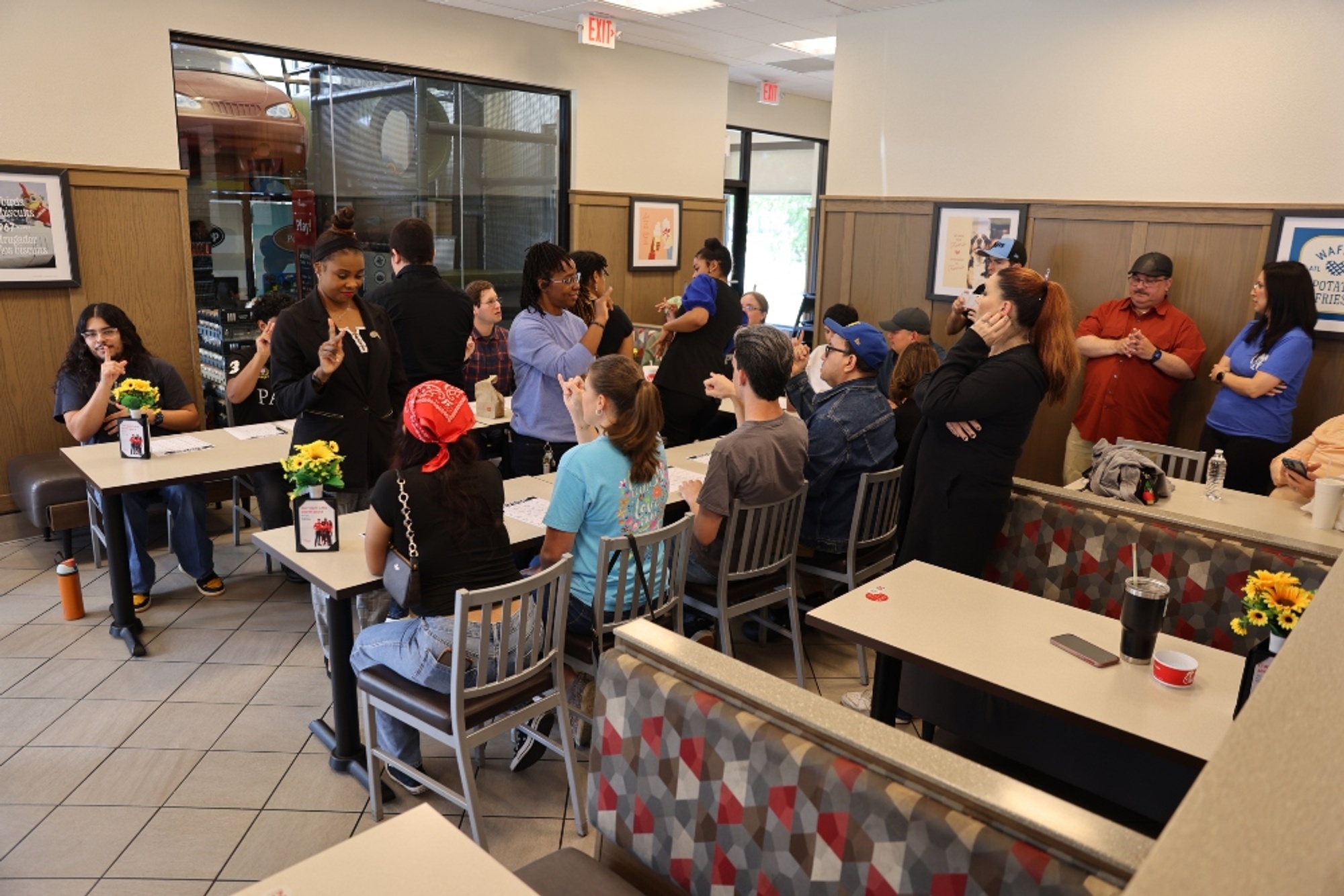 Students in the HCC American Sign Language Honor Society teach sign language to employees at Chick-fil-A.