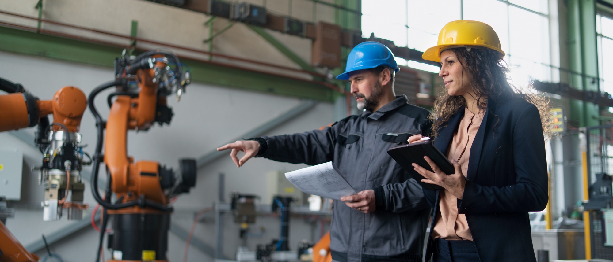 Two Manufacturing Engineers examining manufacturing equipment.