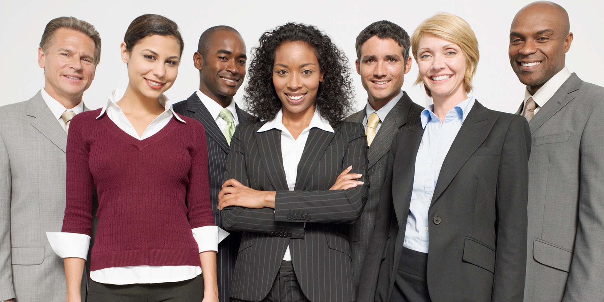 Men and women in business attire smiling