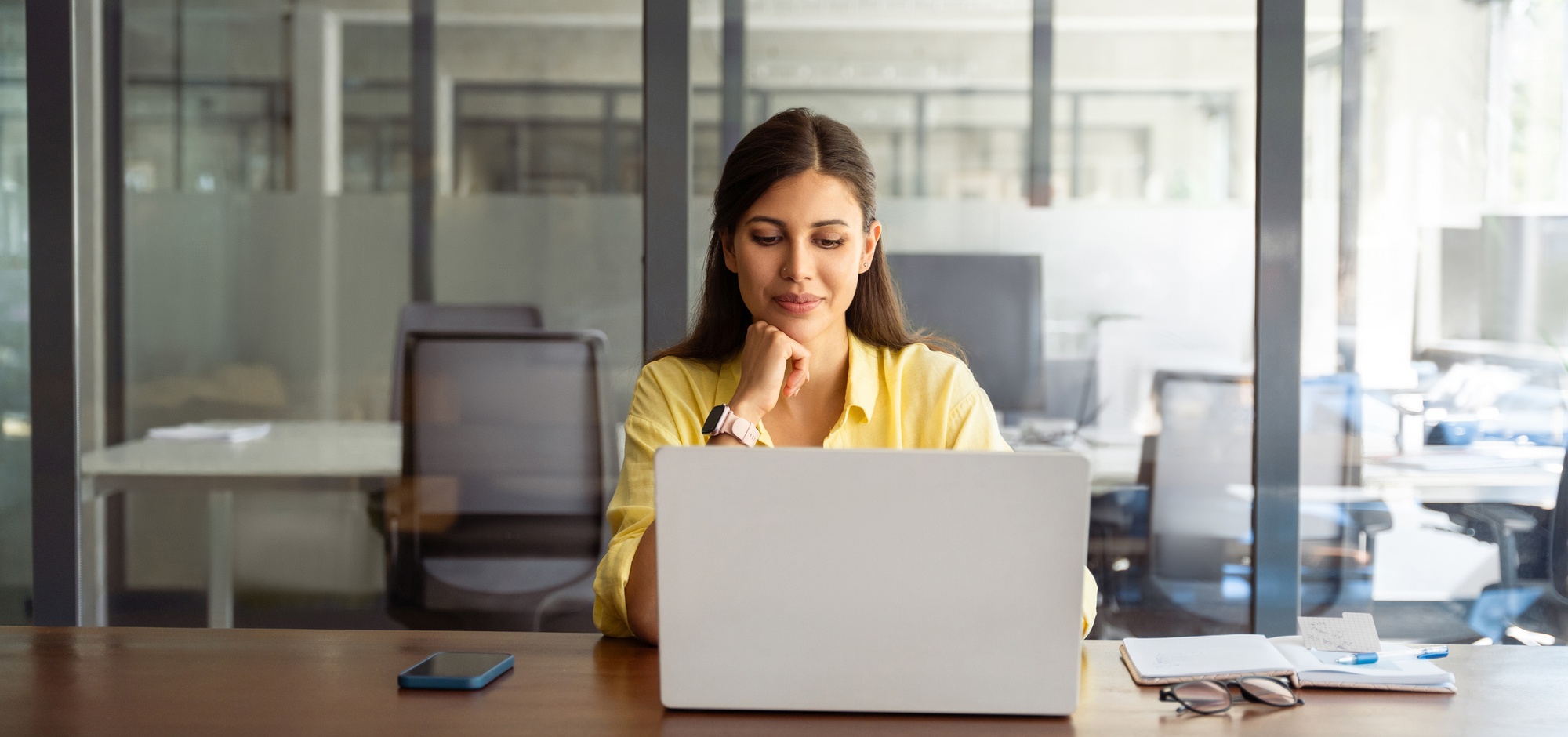 Young female business professional sitting in front of her laptop.