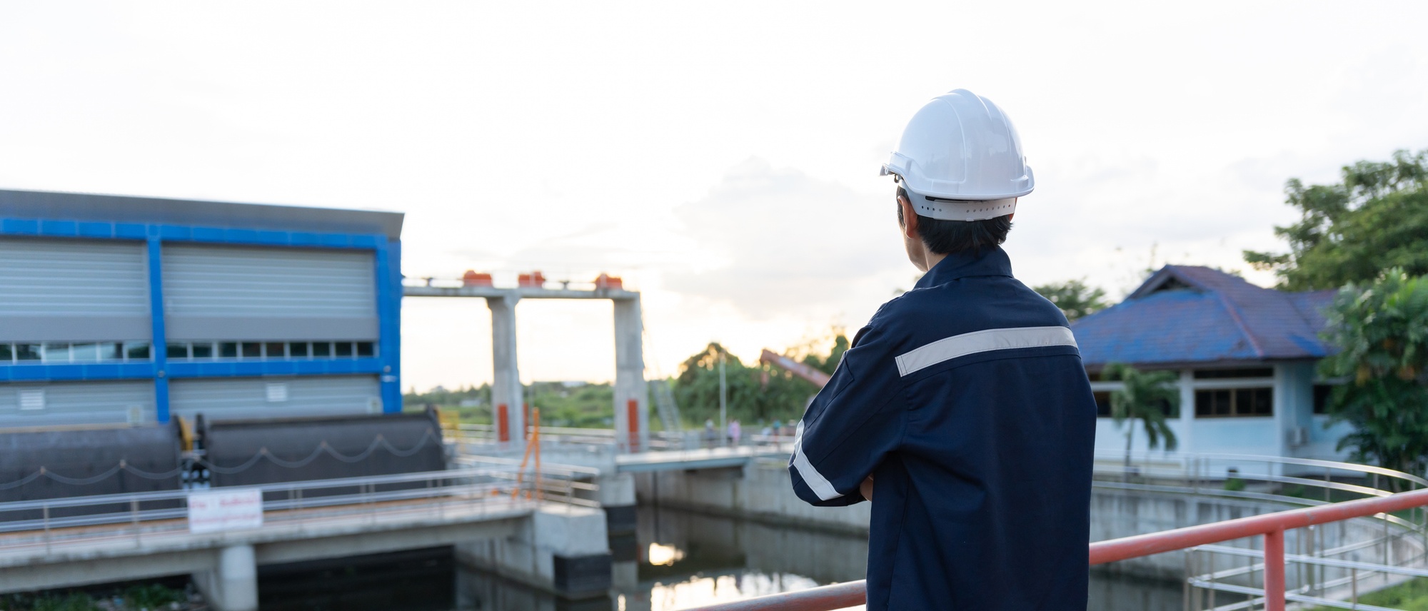 Wastewater engineer overlooking a water treatment facility.